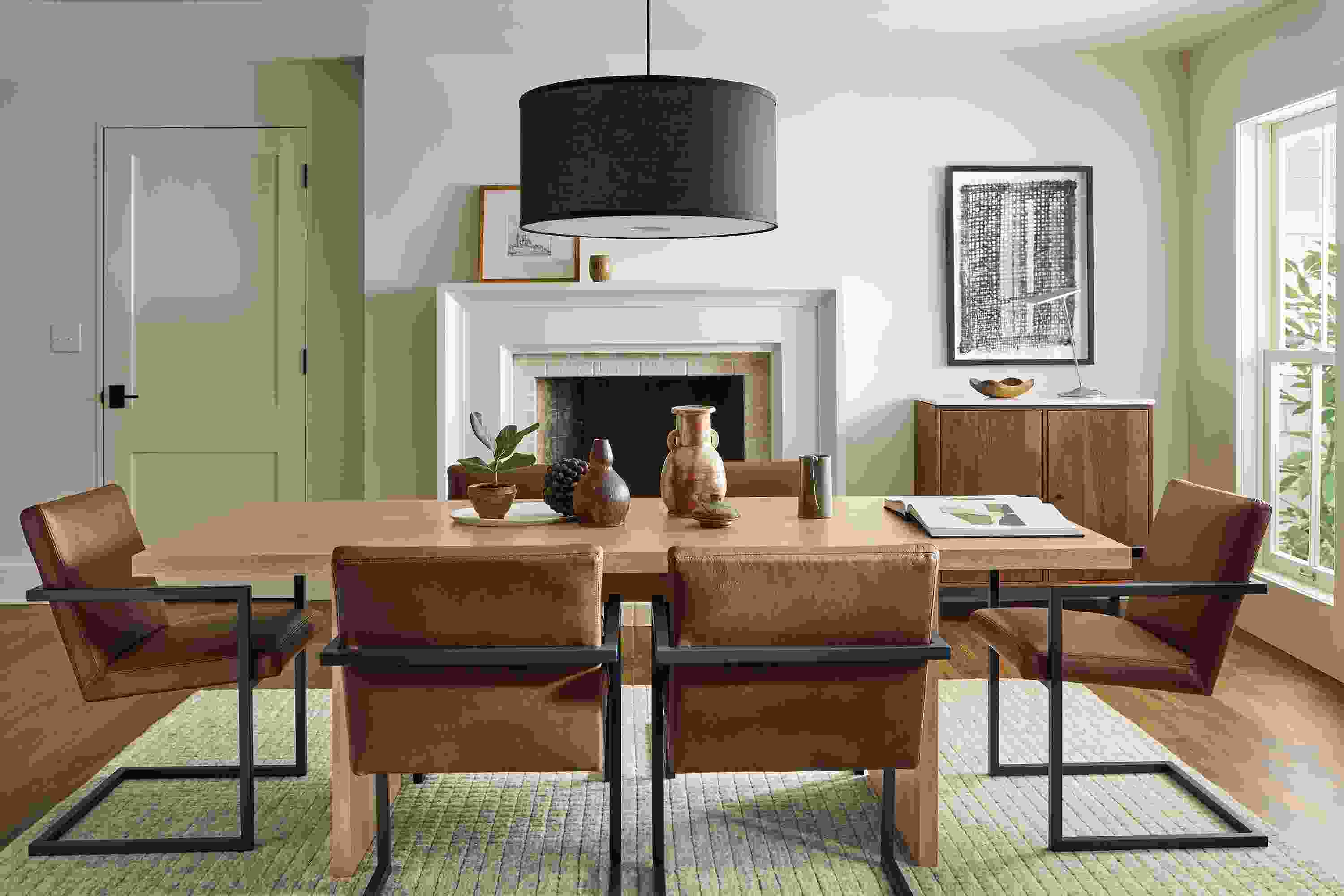 Dining room with Corbett table in rye on red oak and 6 Lira arm chairs in Laino Cognac leather.