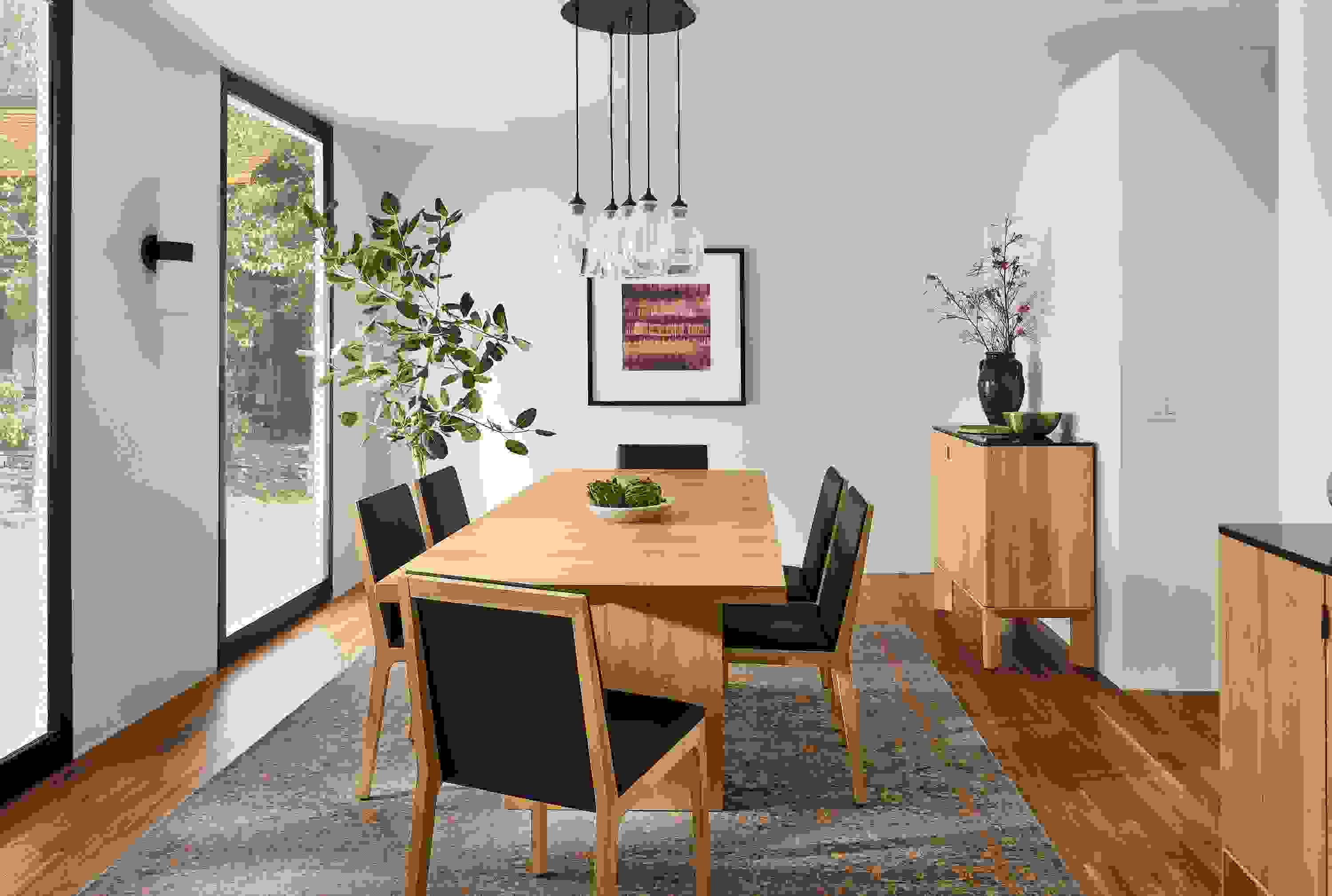 room setting with corbett table in white oak, gabriel chais in white oak and pren cabinets in white oak