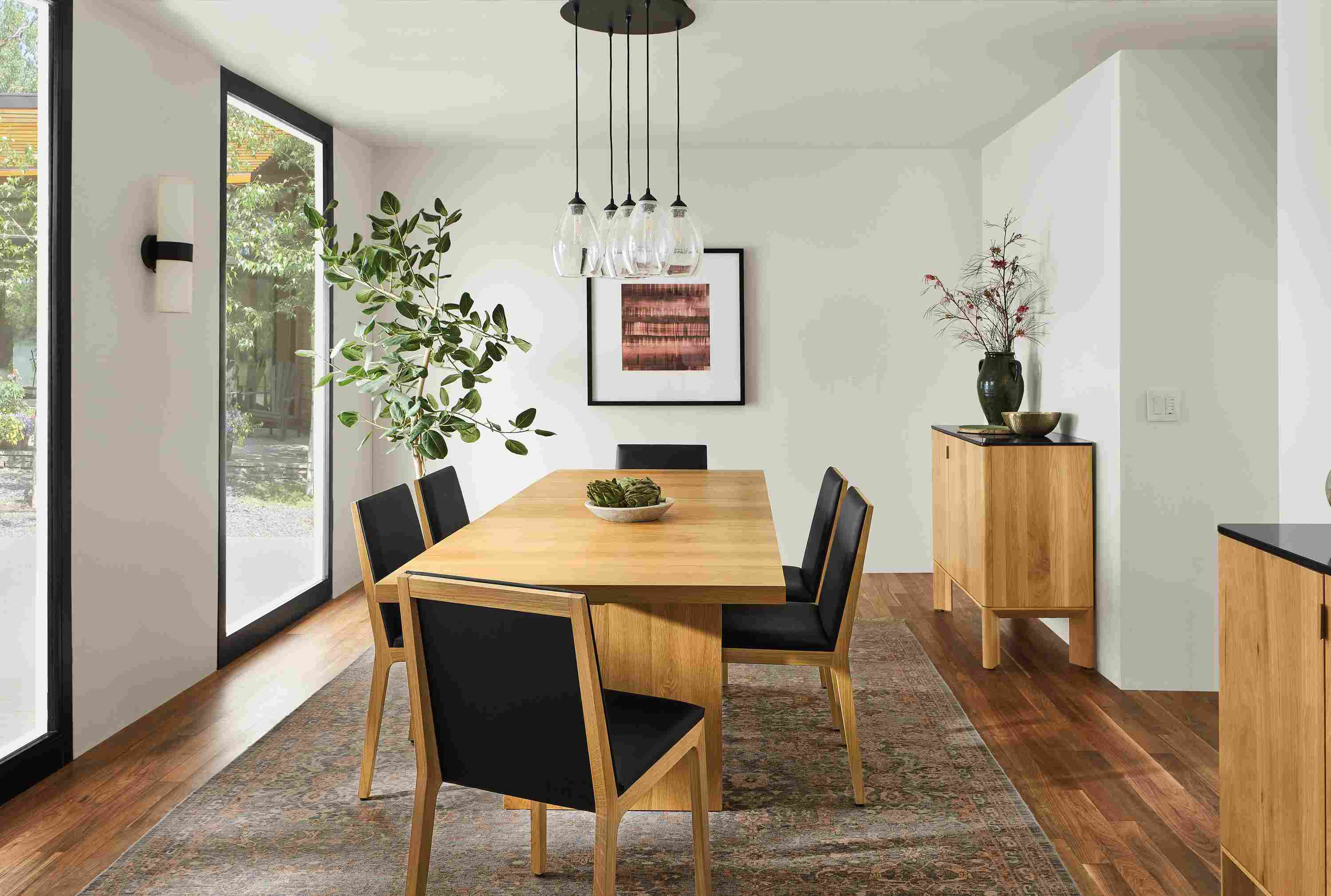 Dining room with corbett table in white oak, gabriel chairs in white oak and pren cabinets in white oak.