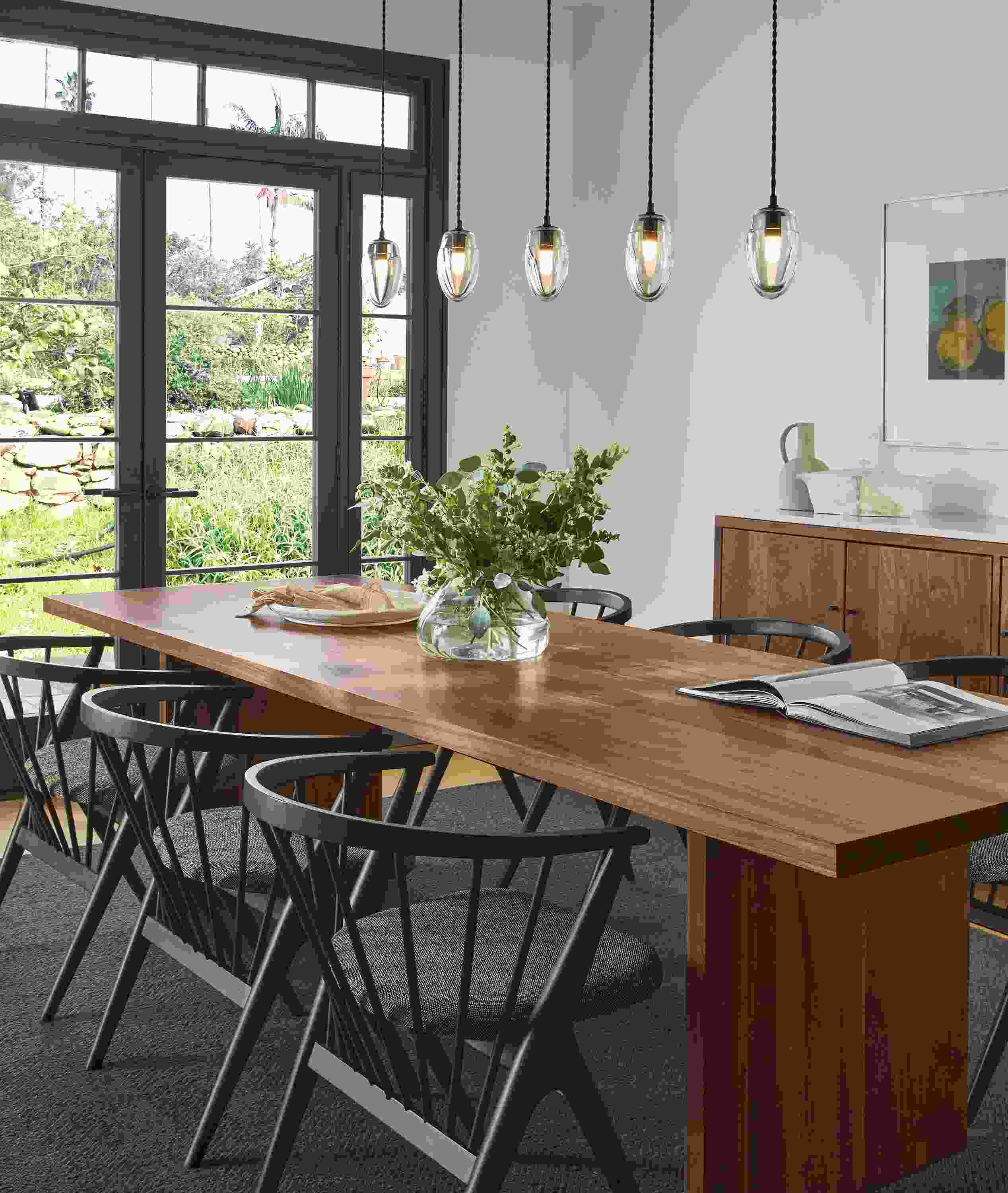 Dining room with Corbett dining table in walnut, Soren chairs, Polar pendant set of five.