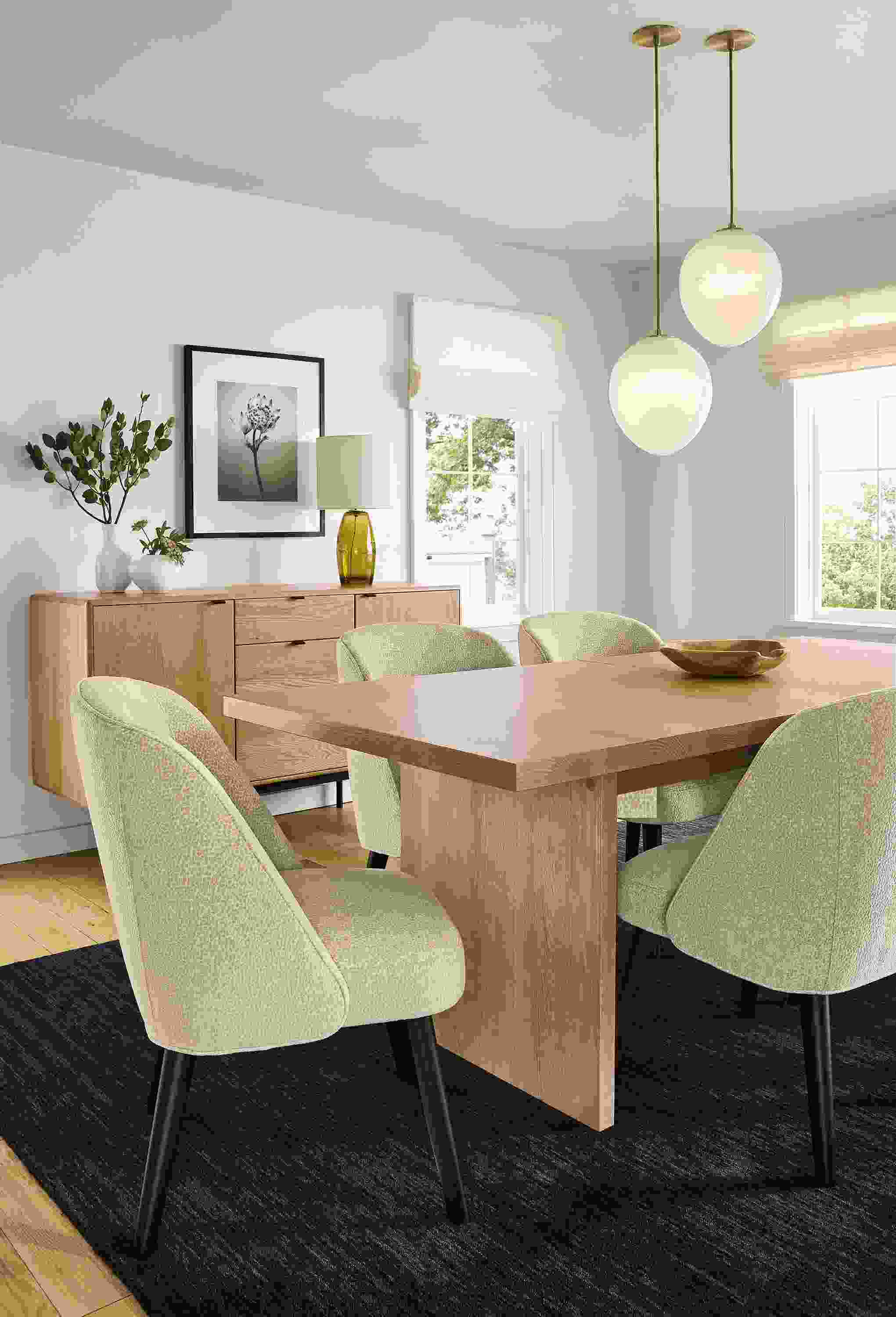 Dining room with corbett 84-wide extension table in rye on red oak, 4 cora side chairs in faron oatmeal and nomad rug in black.