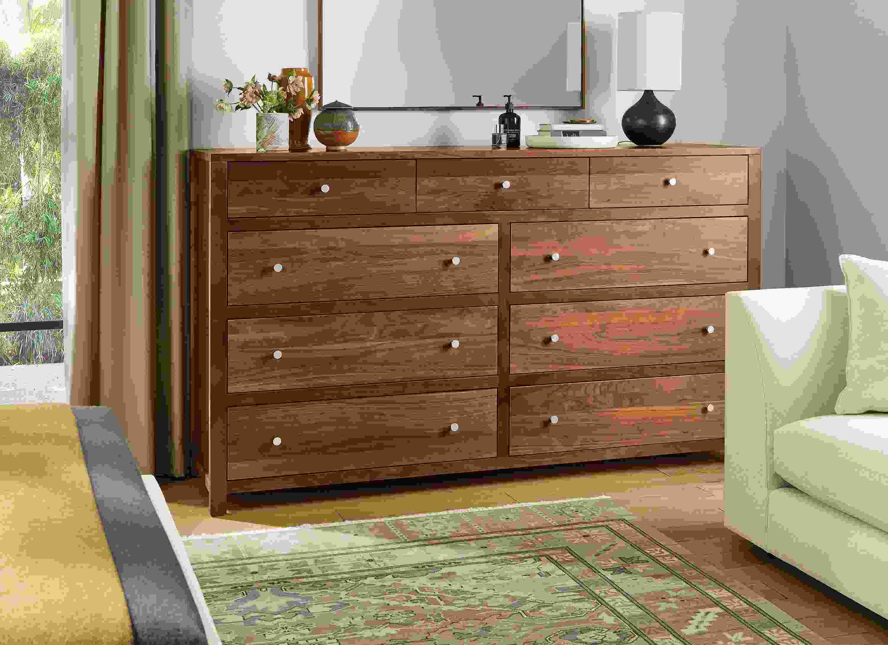 Bedroom area with Corwin 76-wide nine-drawer dresser in walnut, Astaire sofa in Sumner ivory and Kayseri rug in moss.