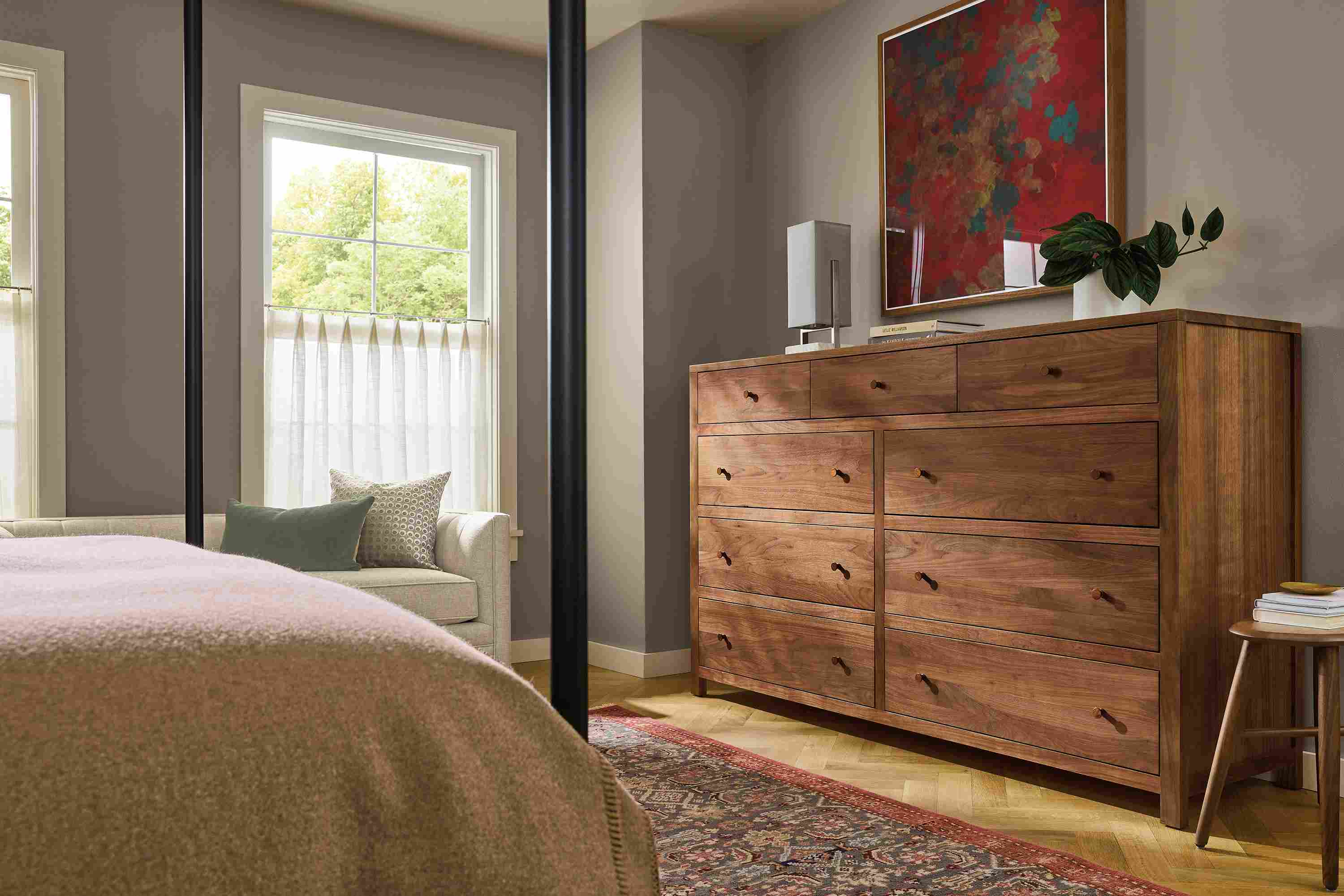 Bedroom with Corwin 76-wide 9-drawer dresser in walnut and Helena 9 by 12 rug in slate.