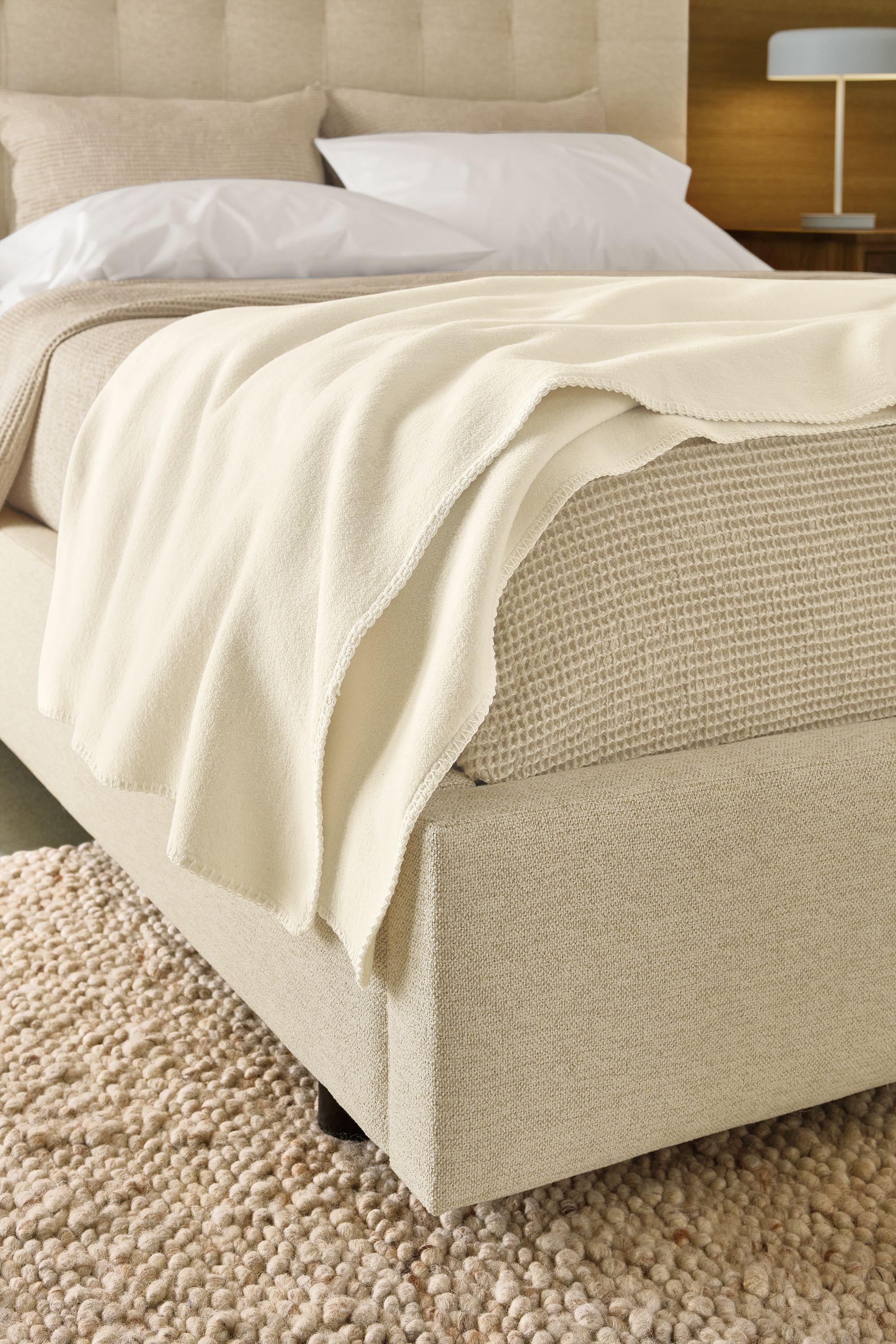 Bedroom with detail of a cotton fleece throw blanket in ivory on an avery storage bed in tatum natural.