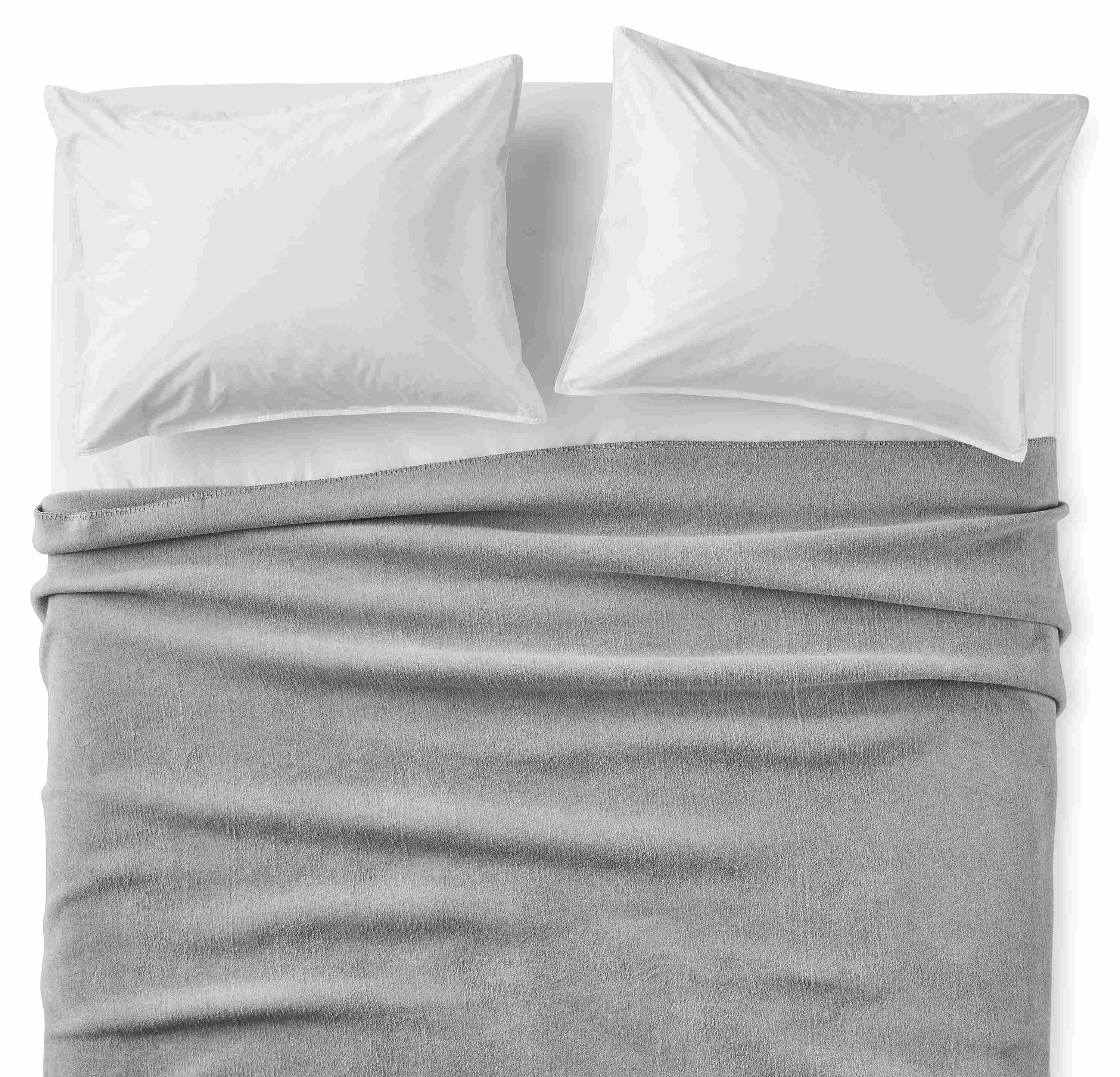 Overhead view of a bed with a cotton fleece full/queen blanket in grey.