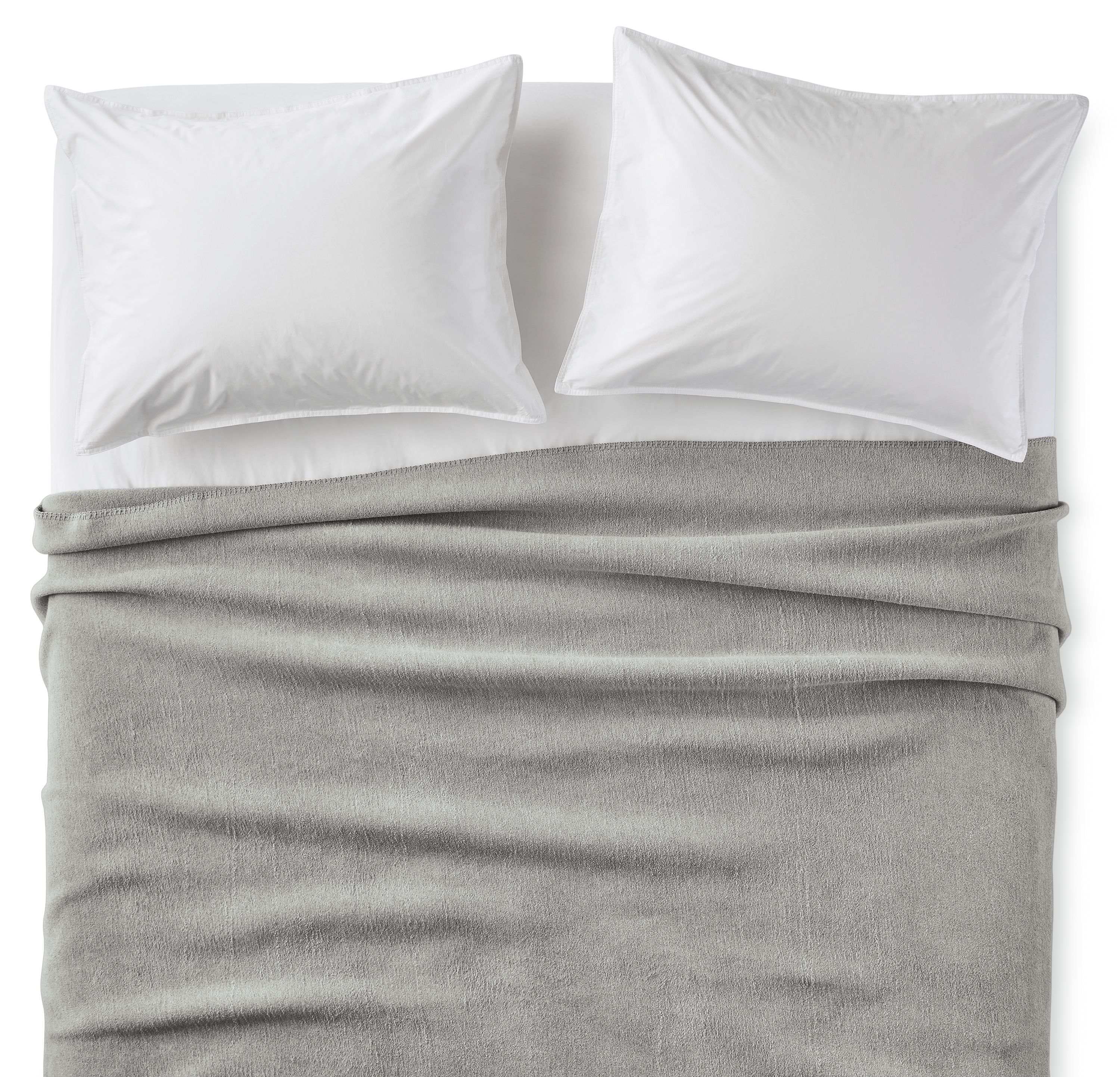 Overhead view of a bed with a cotton fleece full/queen blanket in grey.