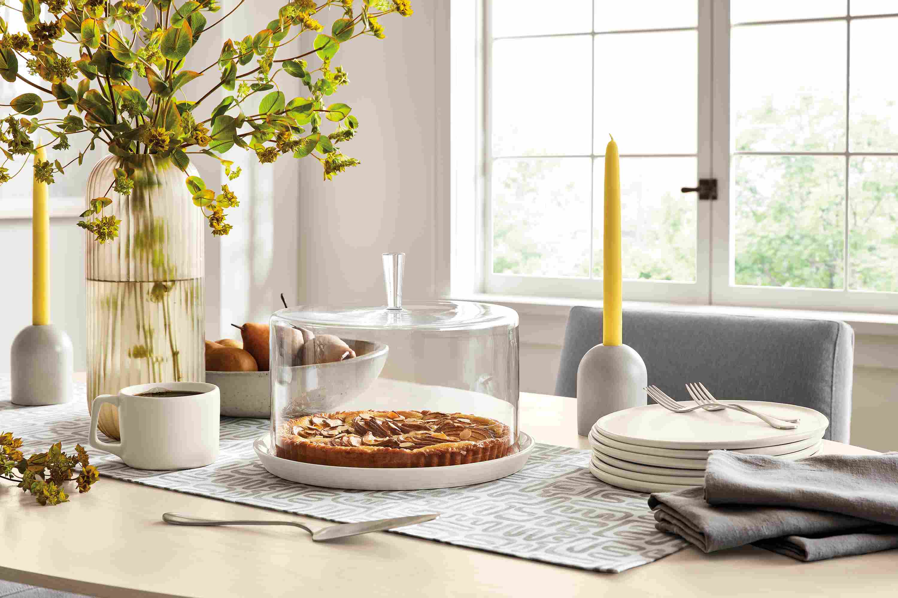 Detail of dining table with Coupole cake dome, Nadia plates, Emile candle holder, Livia table runner.
