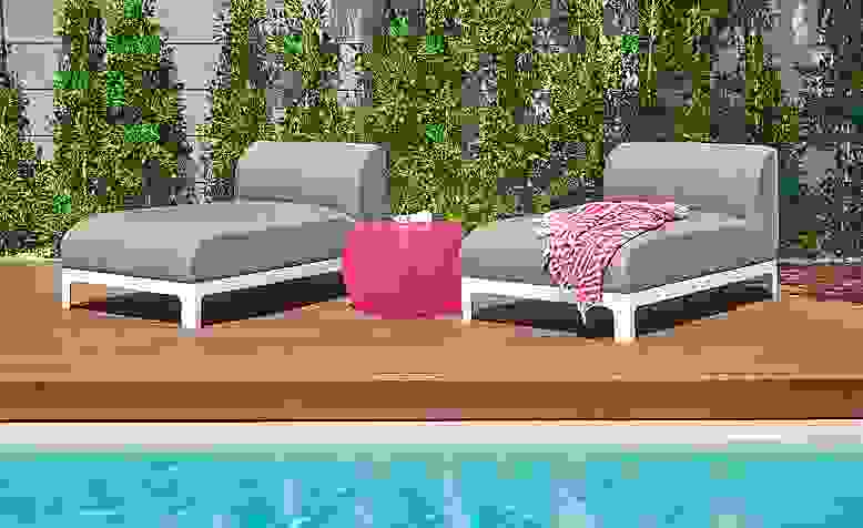 Detail of two Crescent outdoor chaises by pool.