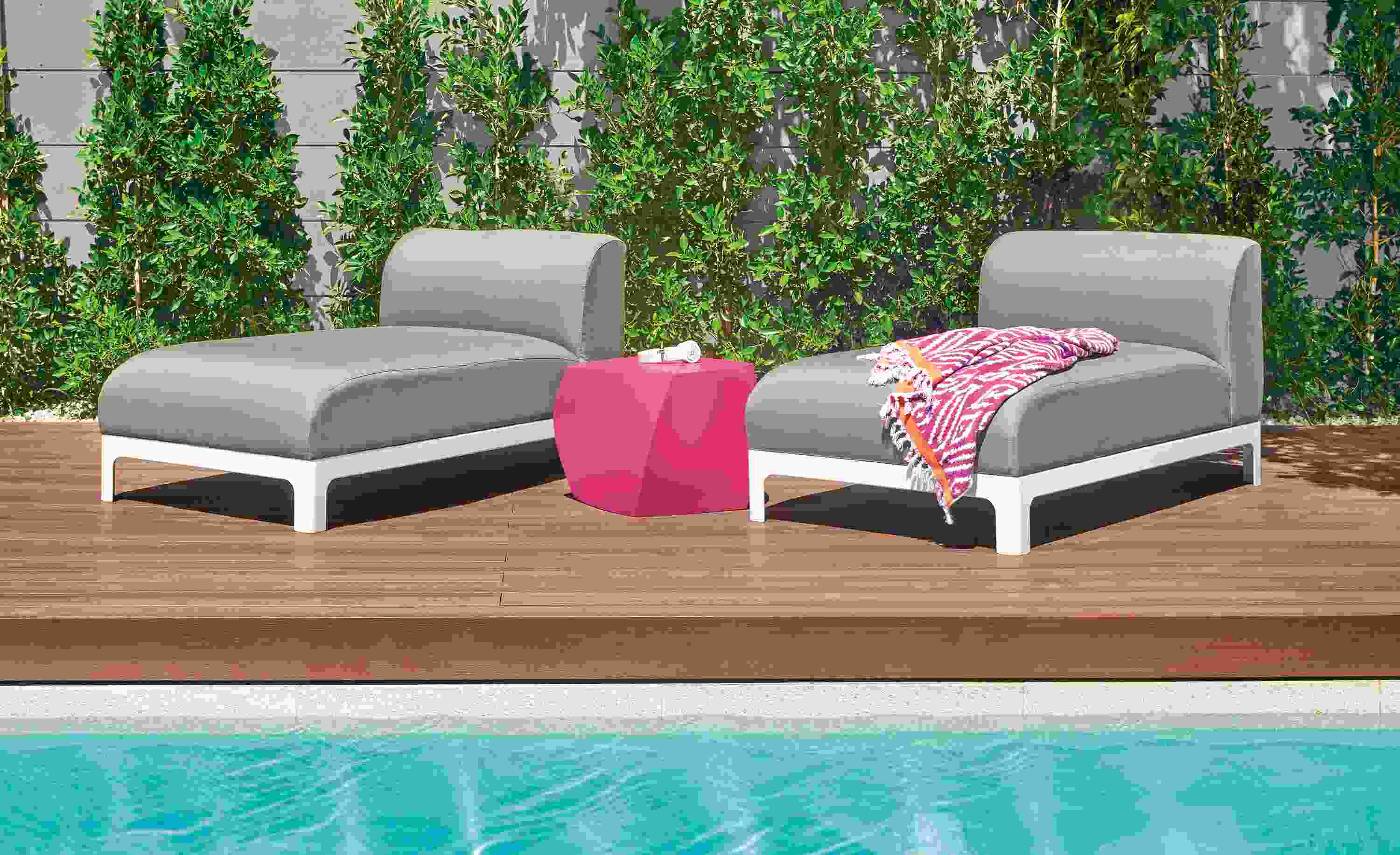 Detail of two Crescent outdoor chaises by pool.