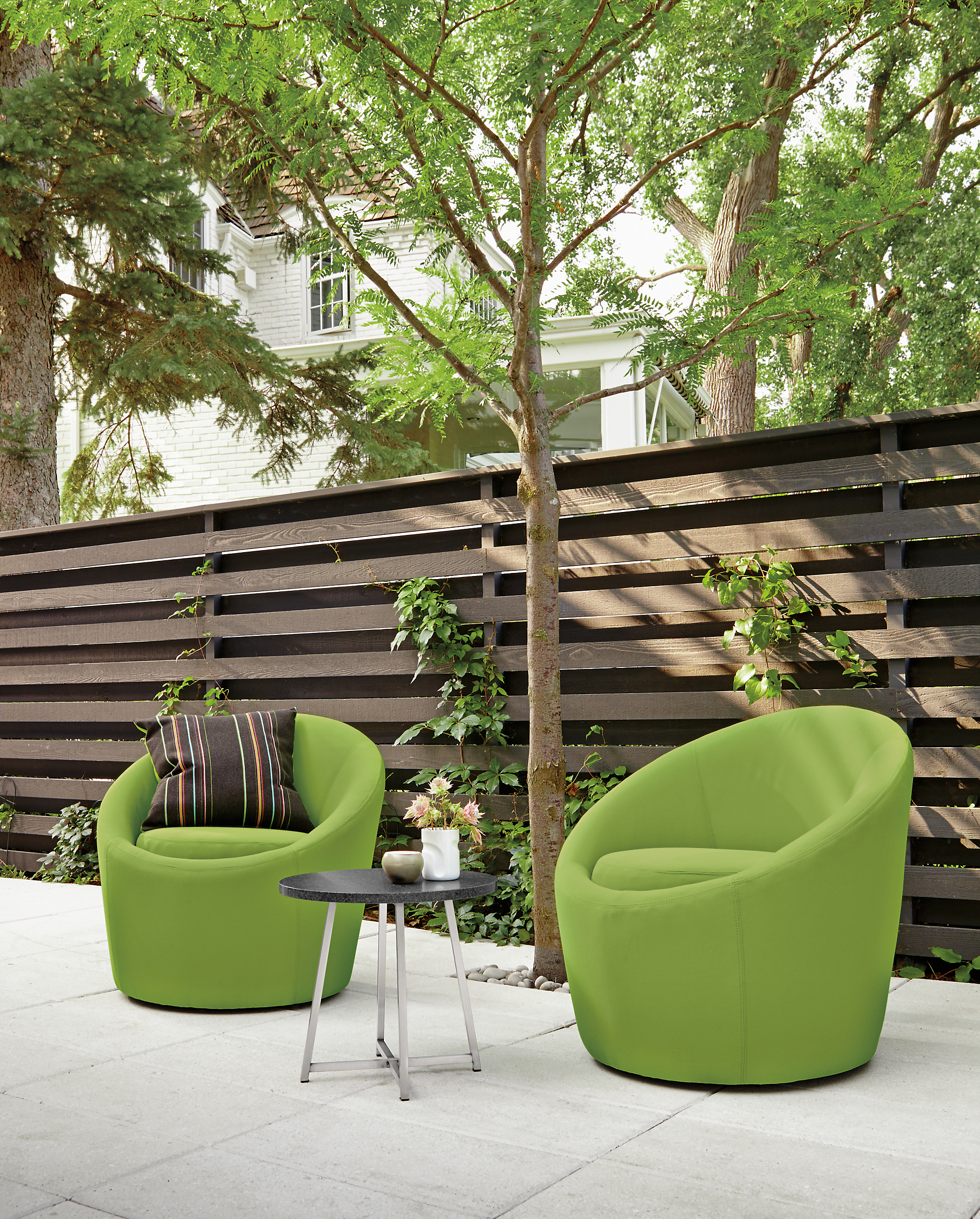 Two green Crest chairs on patio.