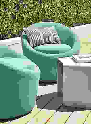 Two Crest outdoor swivel chairs in Niro Teal with Cell table in taupe.