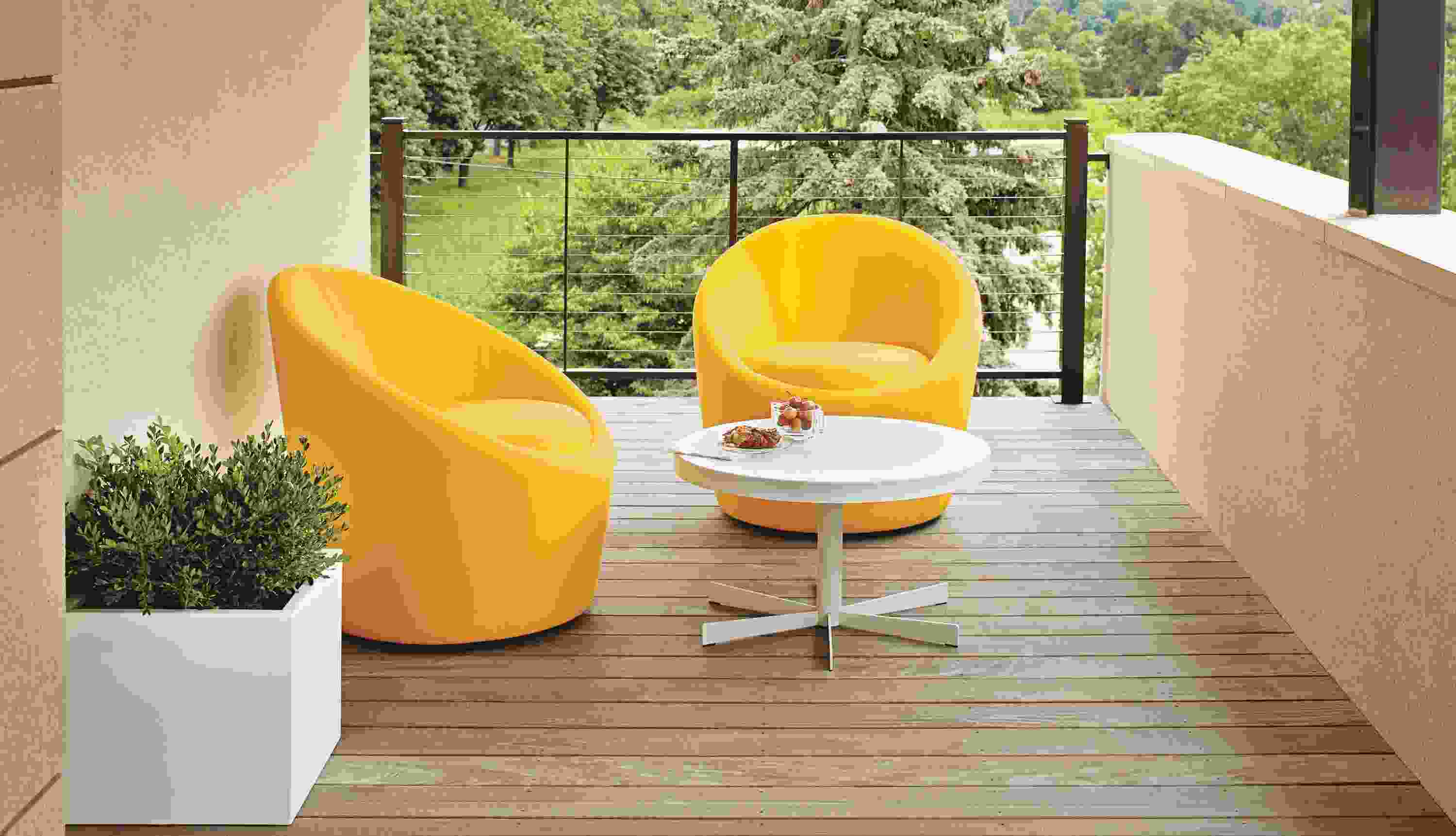 Two yellow Crest chairs on balcony.