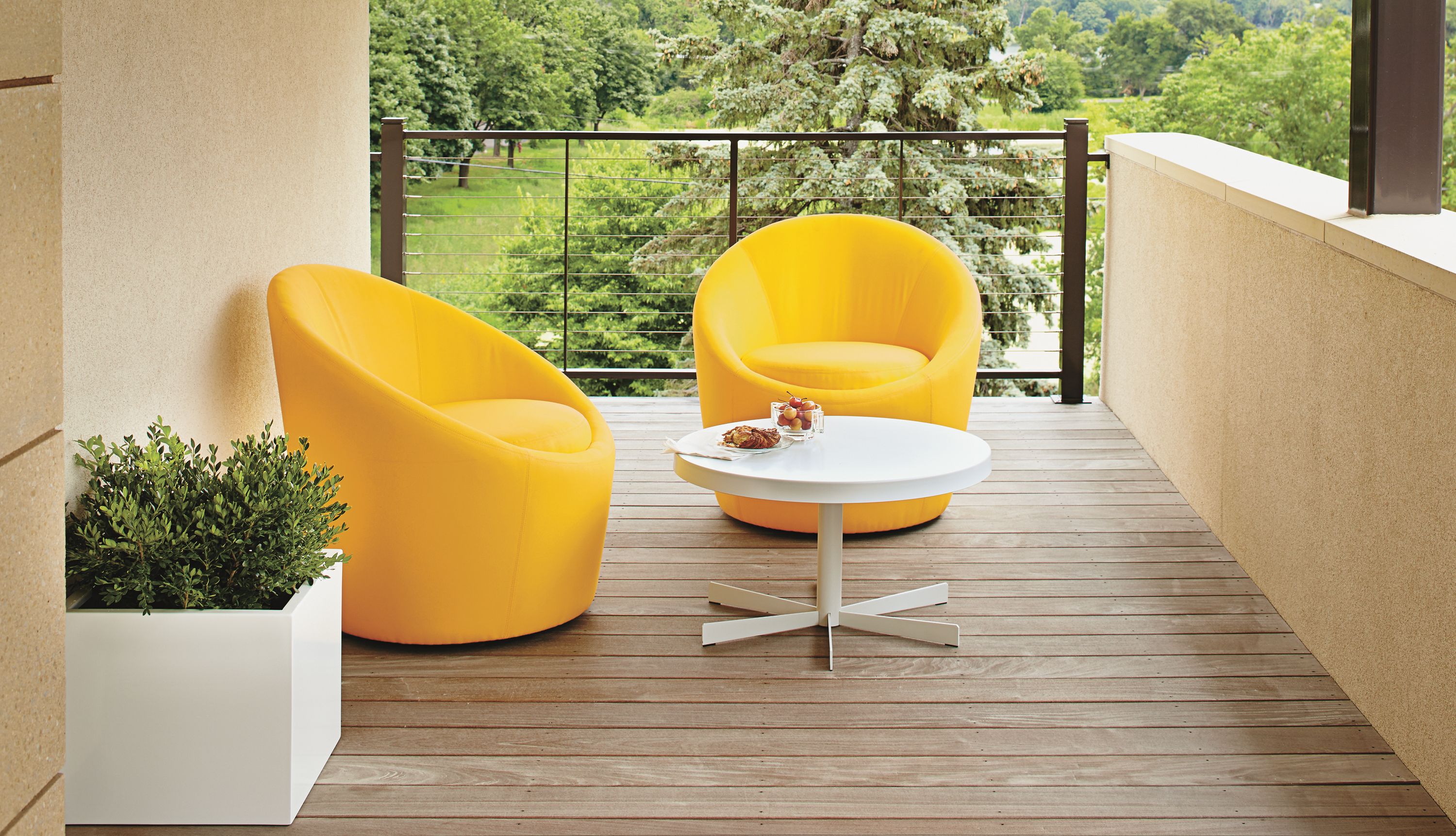 Two yellow Crest chairs on balcony.