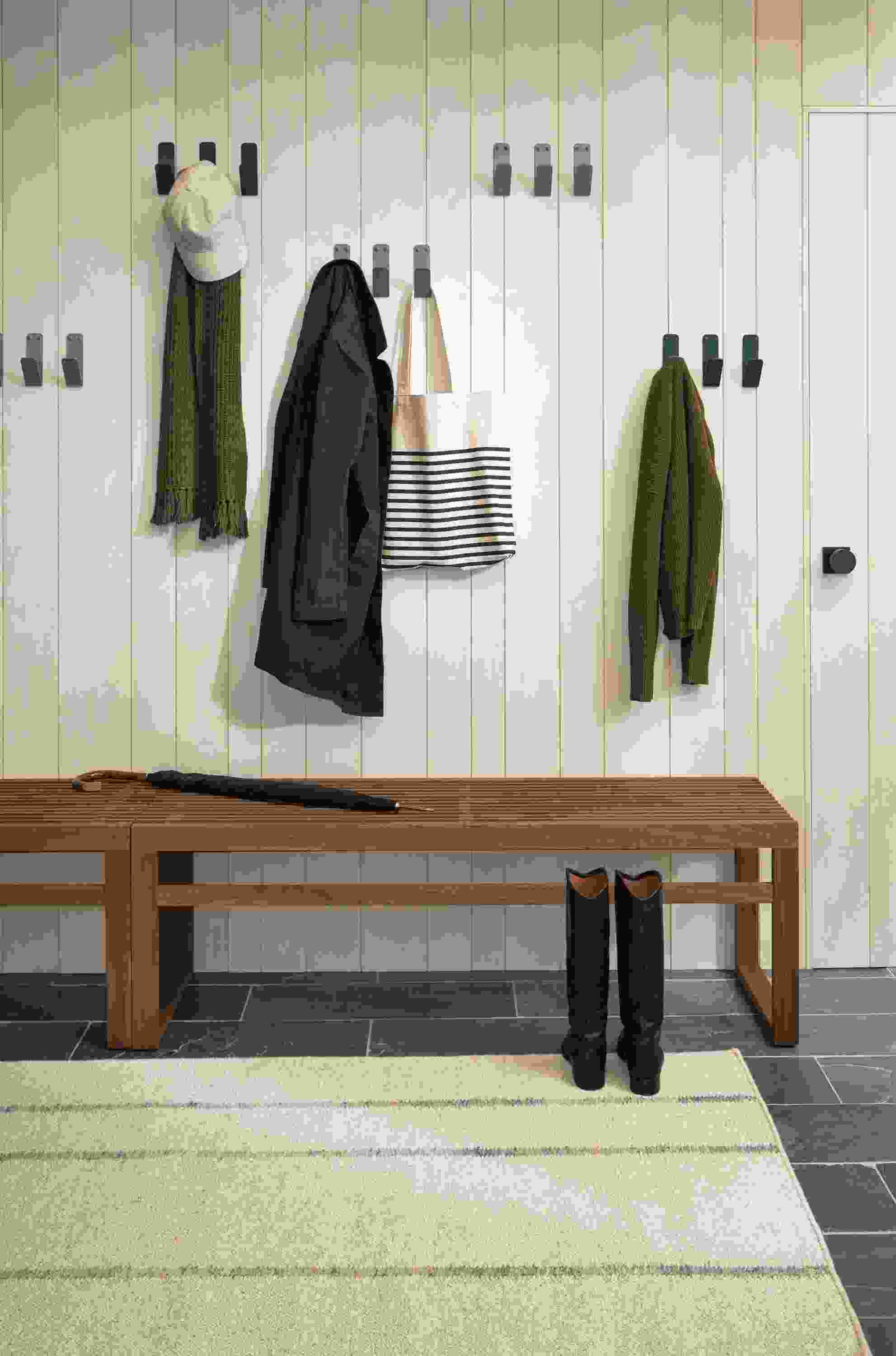 Detail of Crew wall hooks in Slate and Sage colors in entryway.