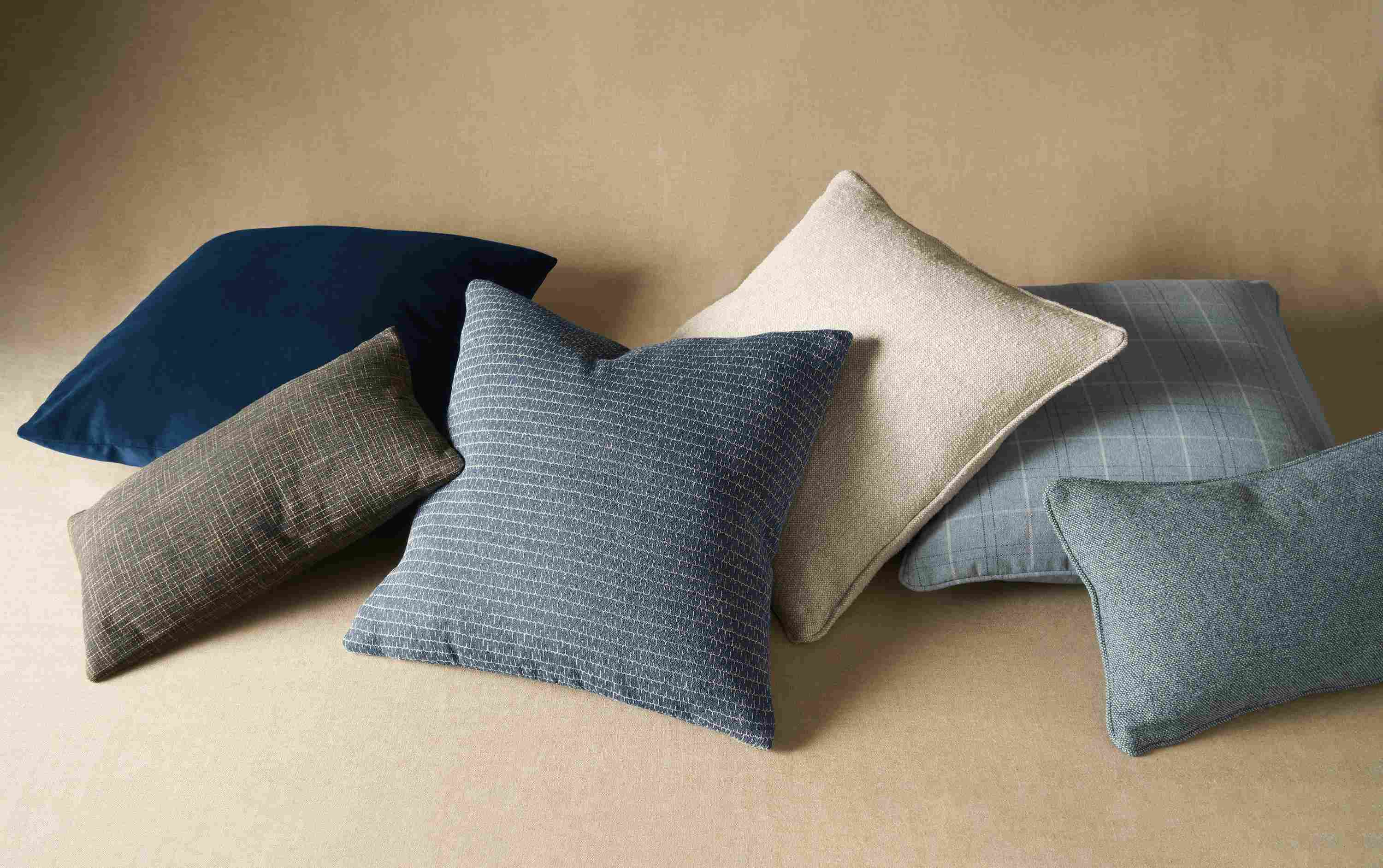 6 custom throw pillows in a pile.