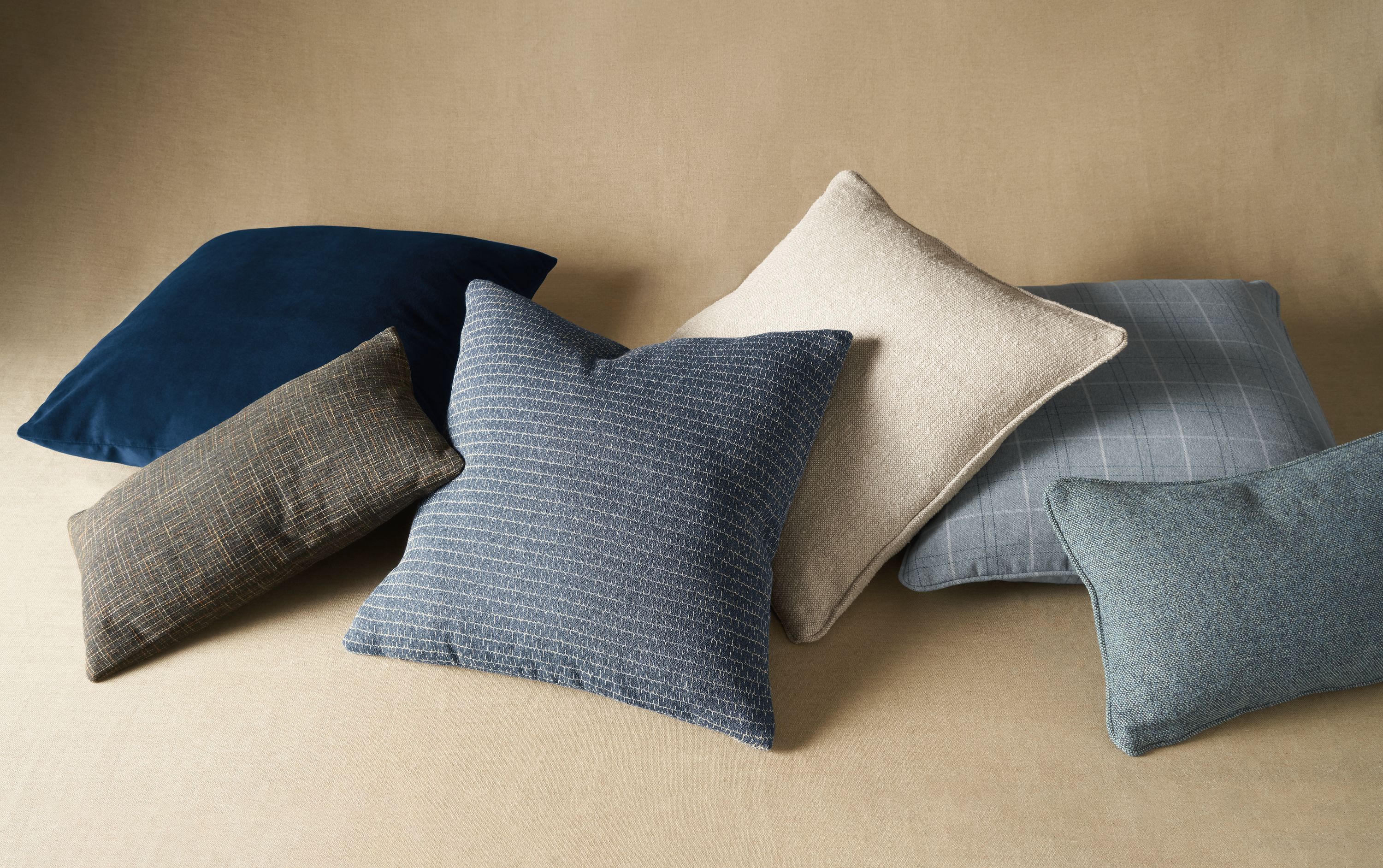 6 custom throw pillows in a pile.
