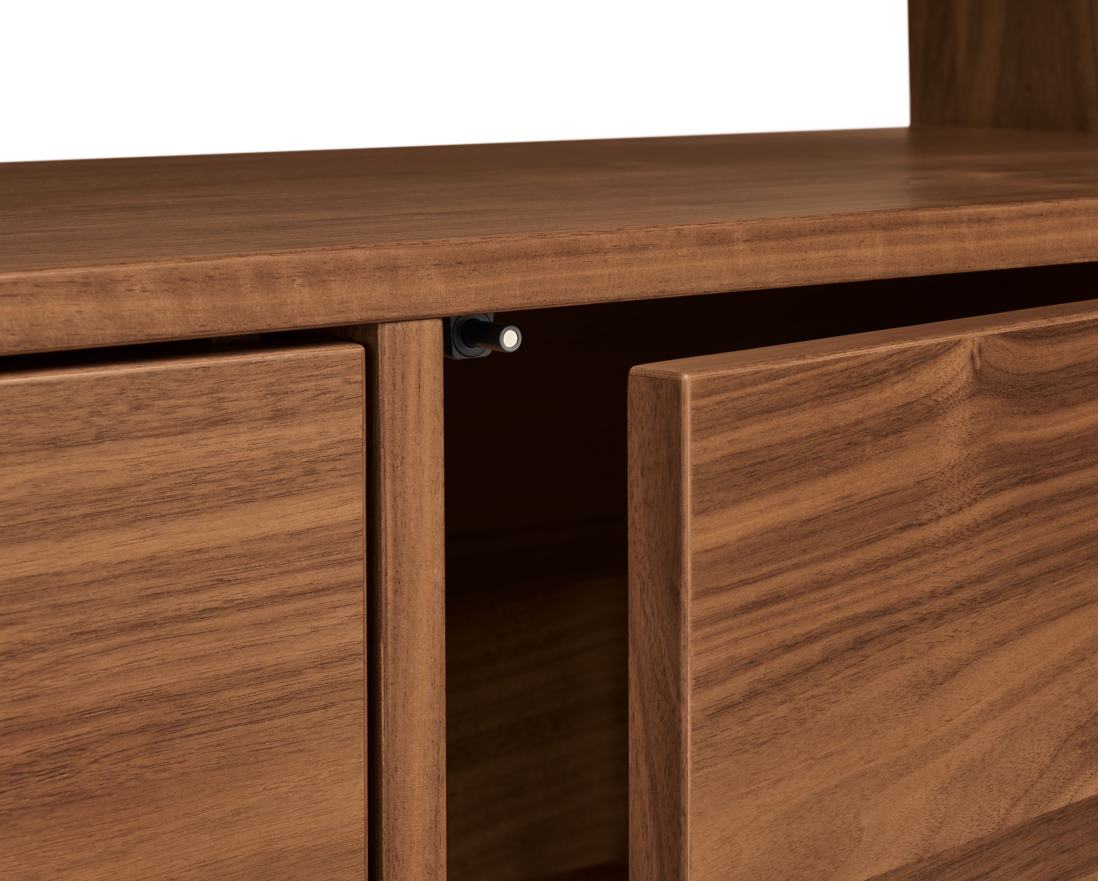 Detail of door-close magnet on a Dahl 2-door bookcase in walnut.