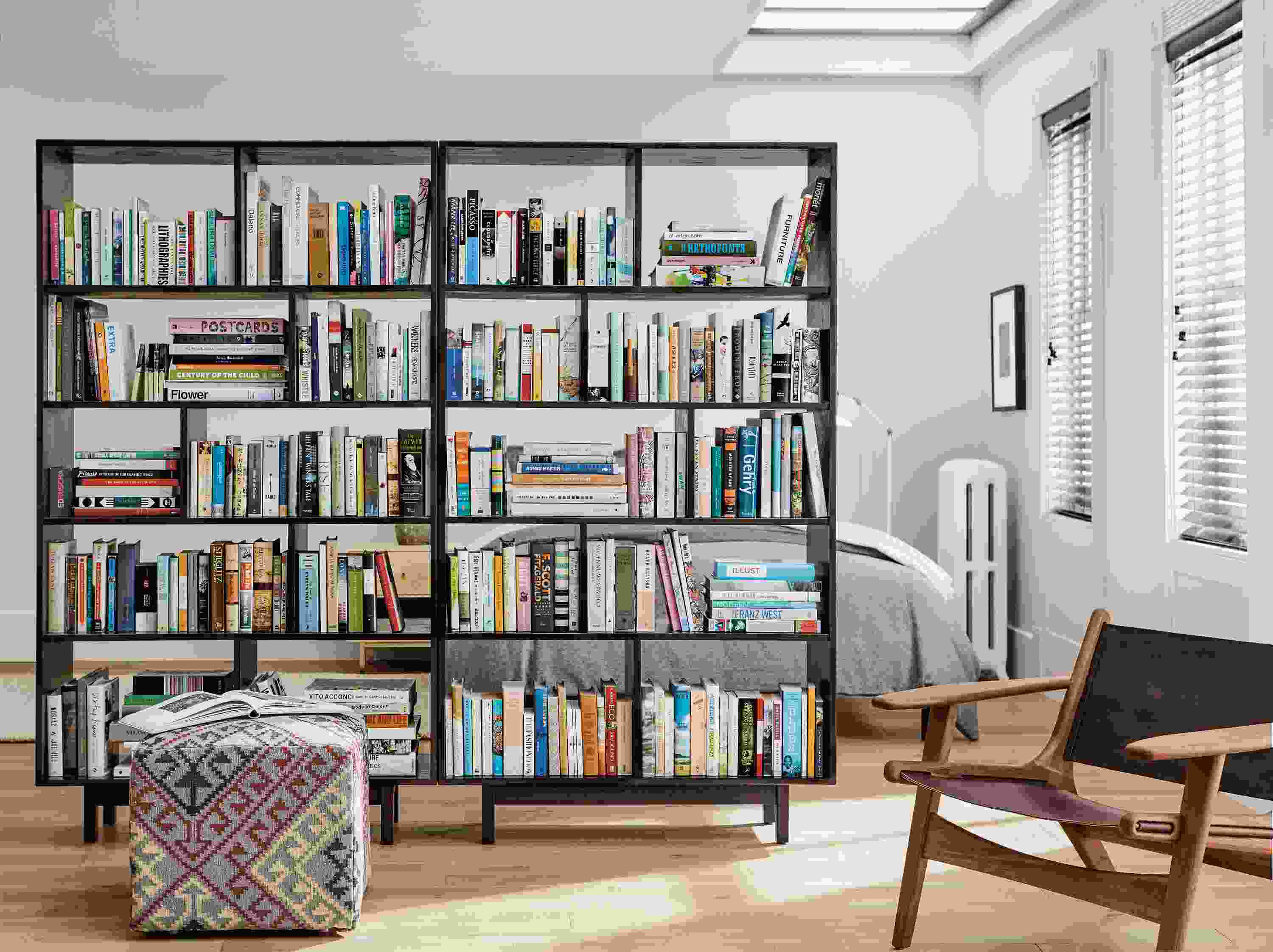 Dahl bookcases separating bedroom and living room.