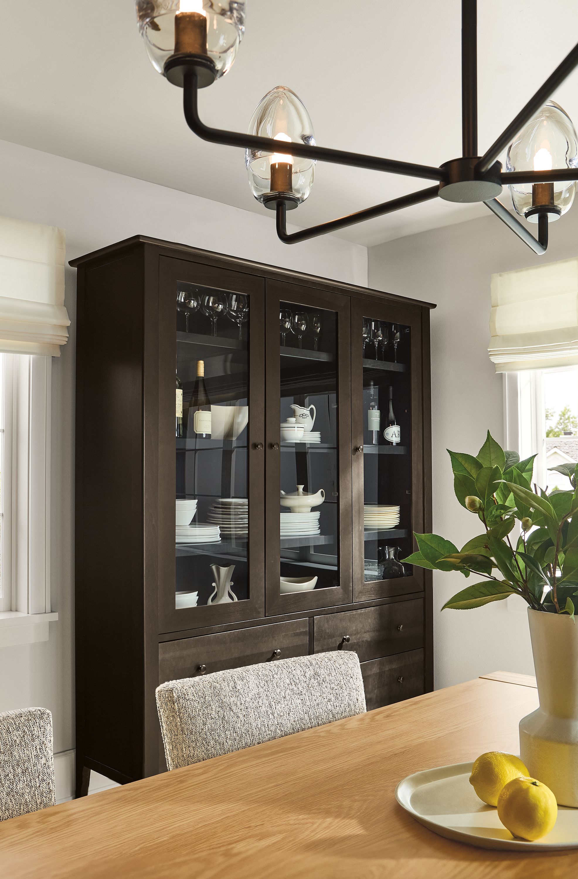 Dining room with Danbury storage cabinet in Charcoal, Walsh table in white oak and Polar Chandelier.