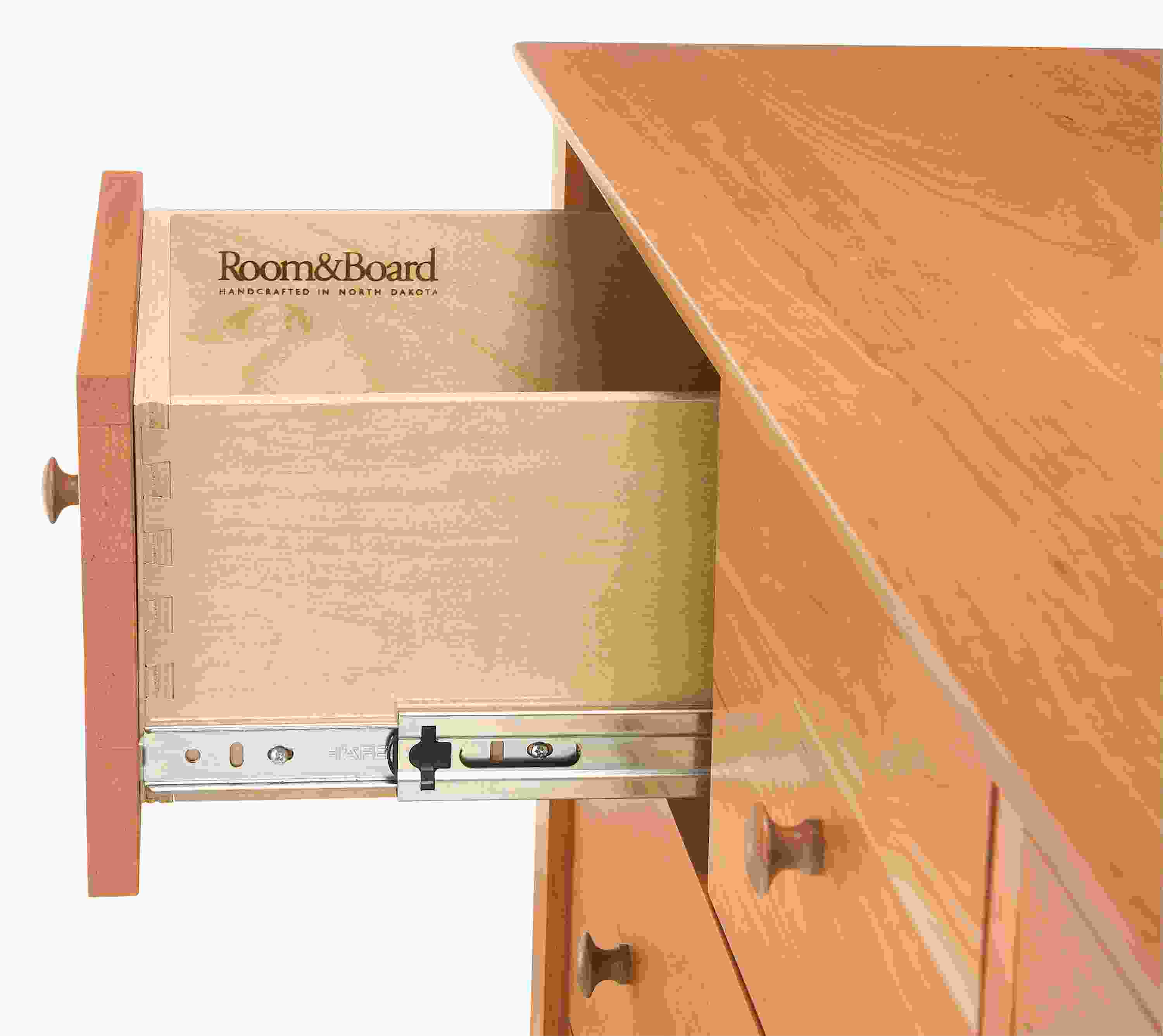 Detail of drawer slide on a Danbury ten-drawer dresser in Cherry.