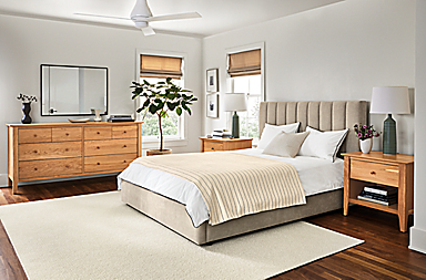 Bedroom with Danbury 75-wide eight-drawer dresser in cherry and Hartley storage bed in Mori Oatmeal.