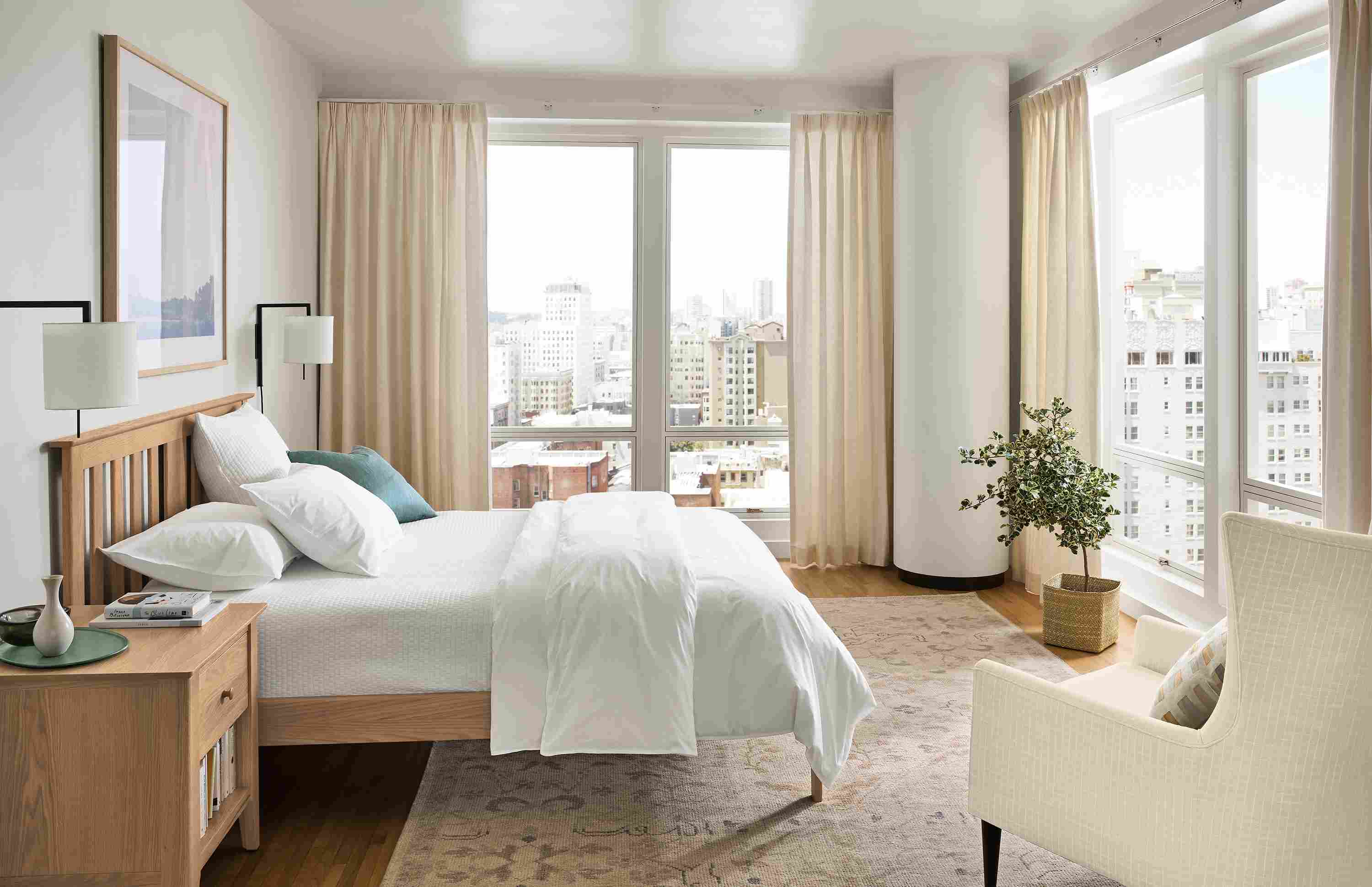 Bedroom with danbury queen low footboard bed in rye on red oak, bradford chair in prado natural and ophelia rug in pumice.