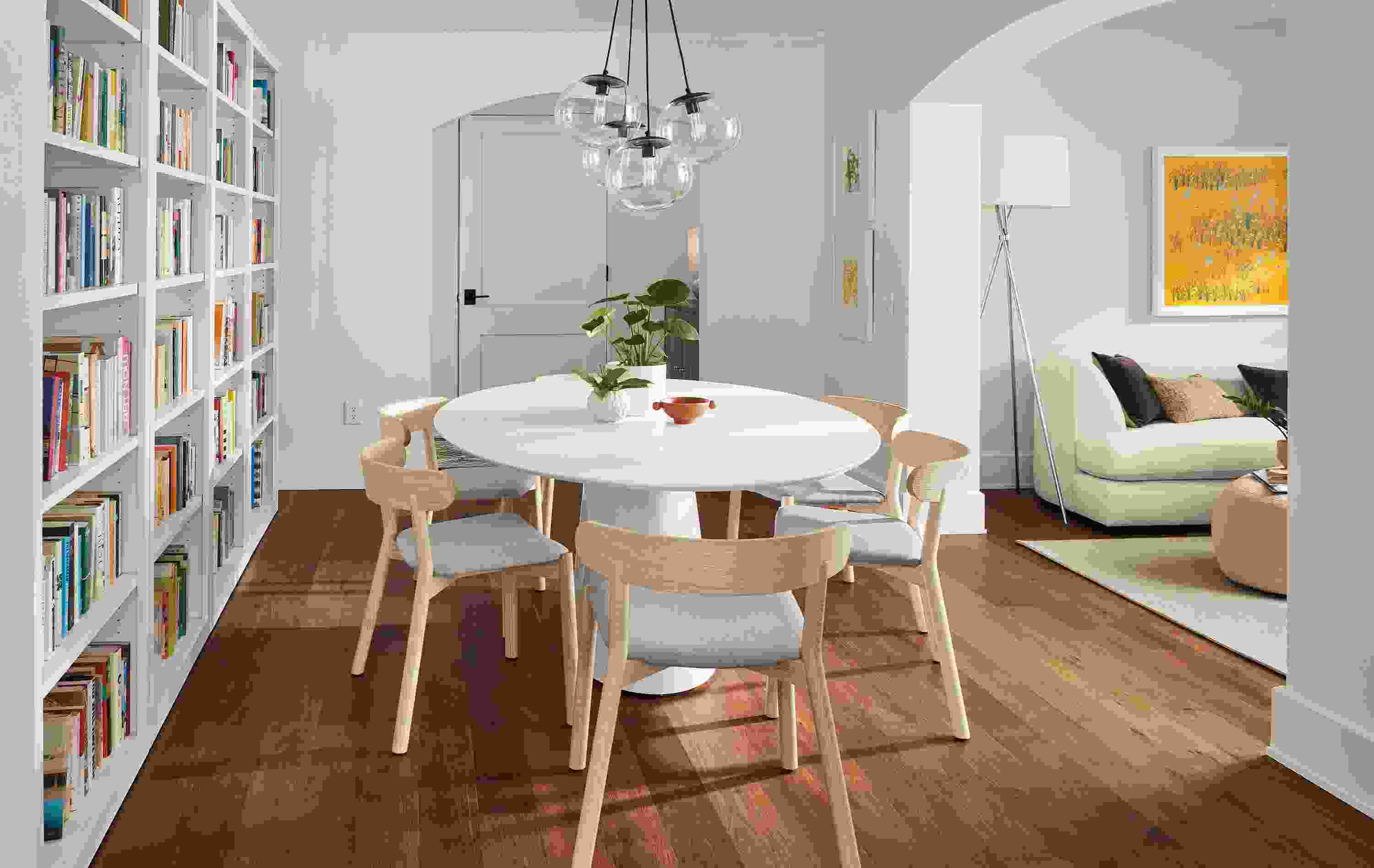 Dining room with Decker dining table with white base and white quartz top and 6 Erwin chairs in creel cement and ash.