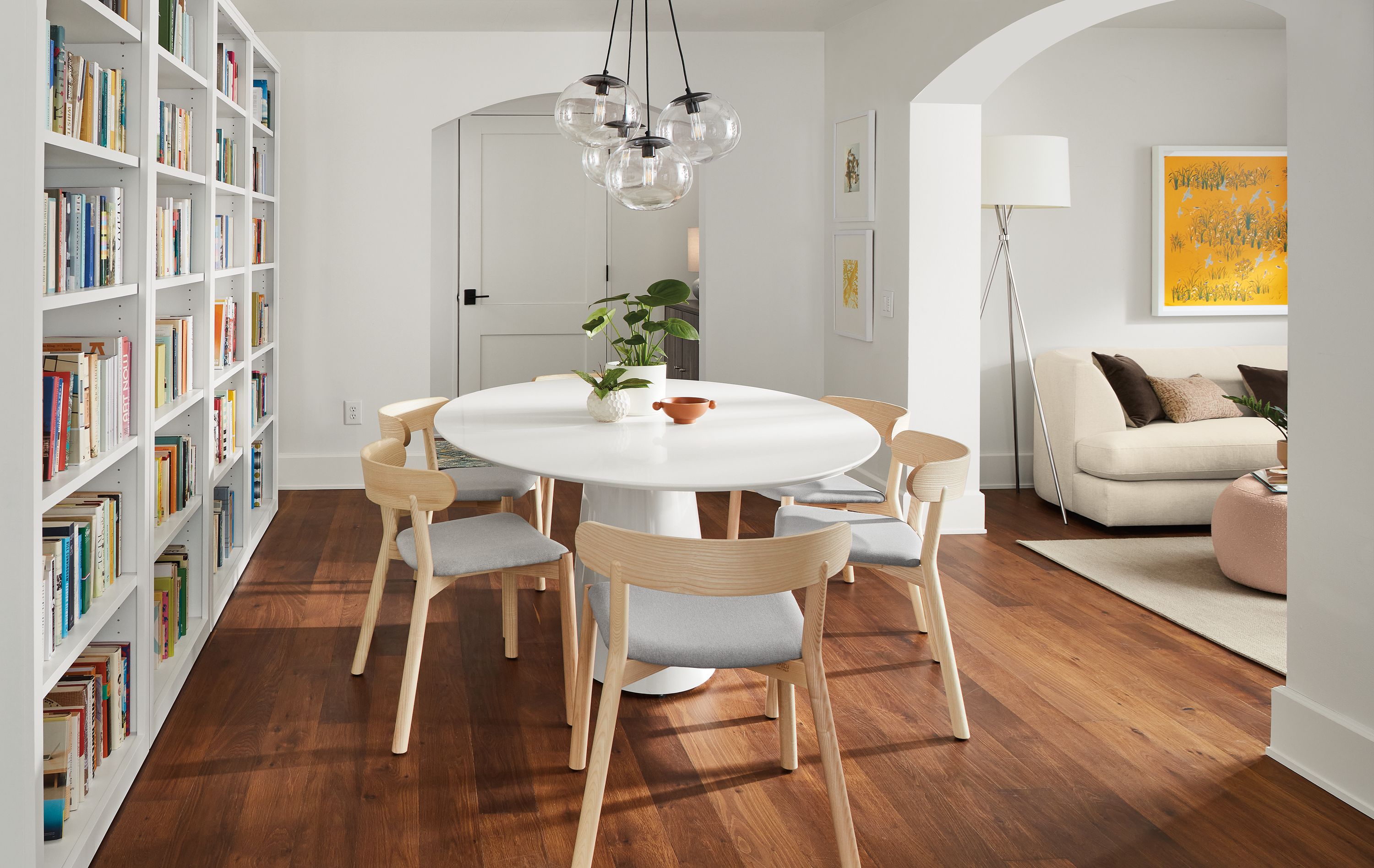 Dining room with Decker dining table with white base and white quartz top and 6 Erwin chairs in creel cement and ash.