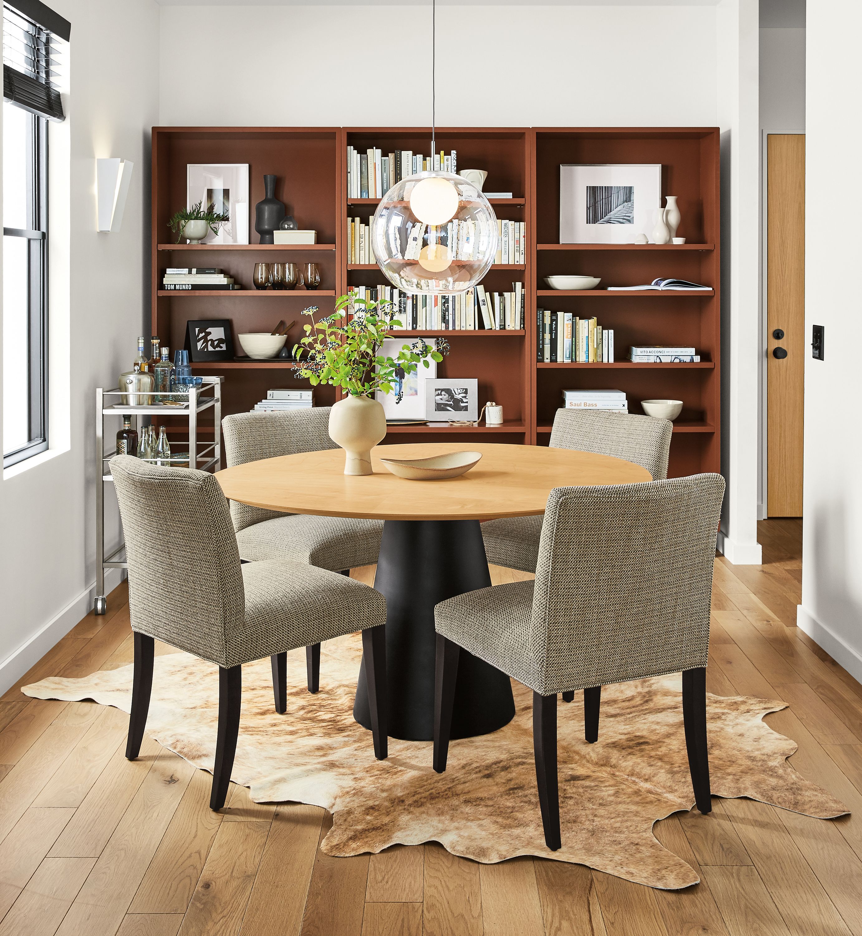 Detail of Decker round table with maple top and graphite base in dining room.