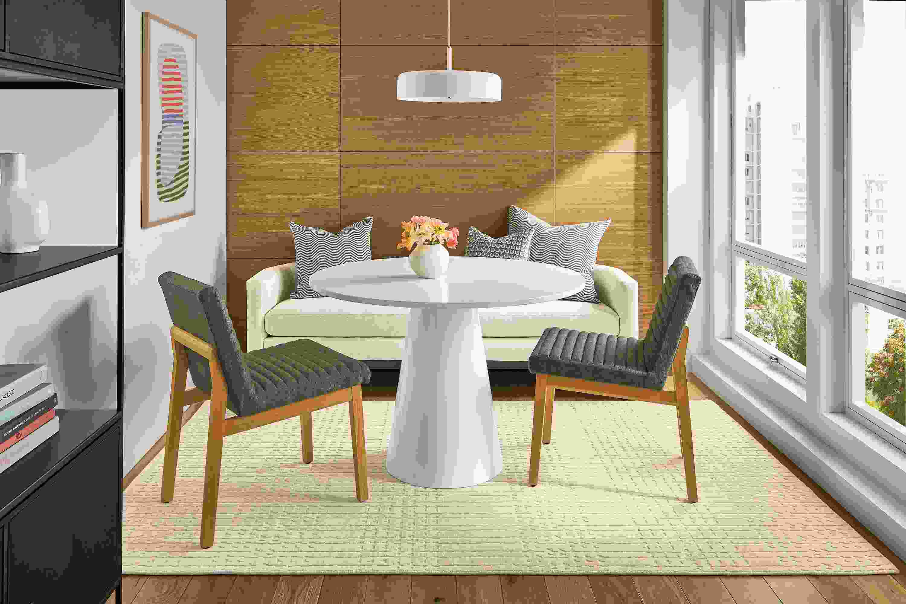 Small seating area with Decker round table in white with white quartz and Silva bench in Sumner Ivory.