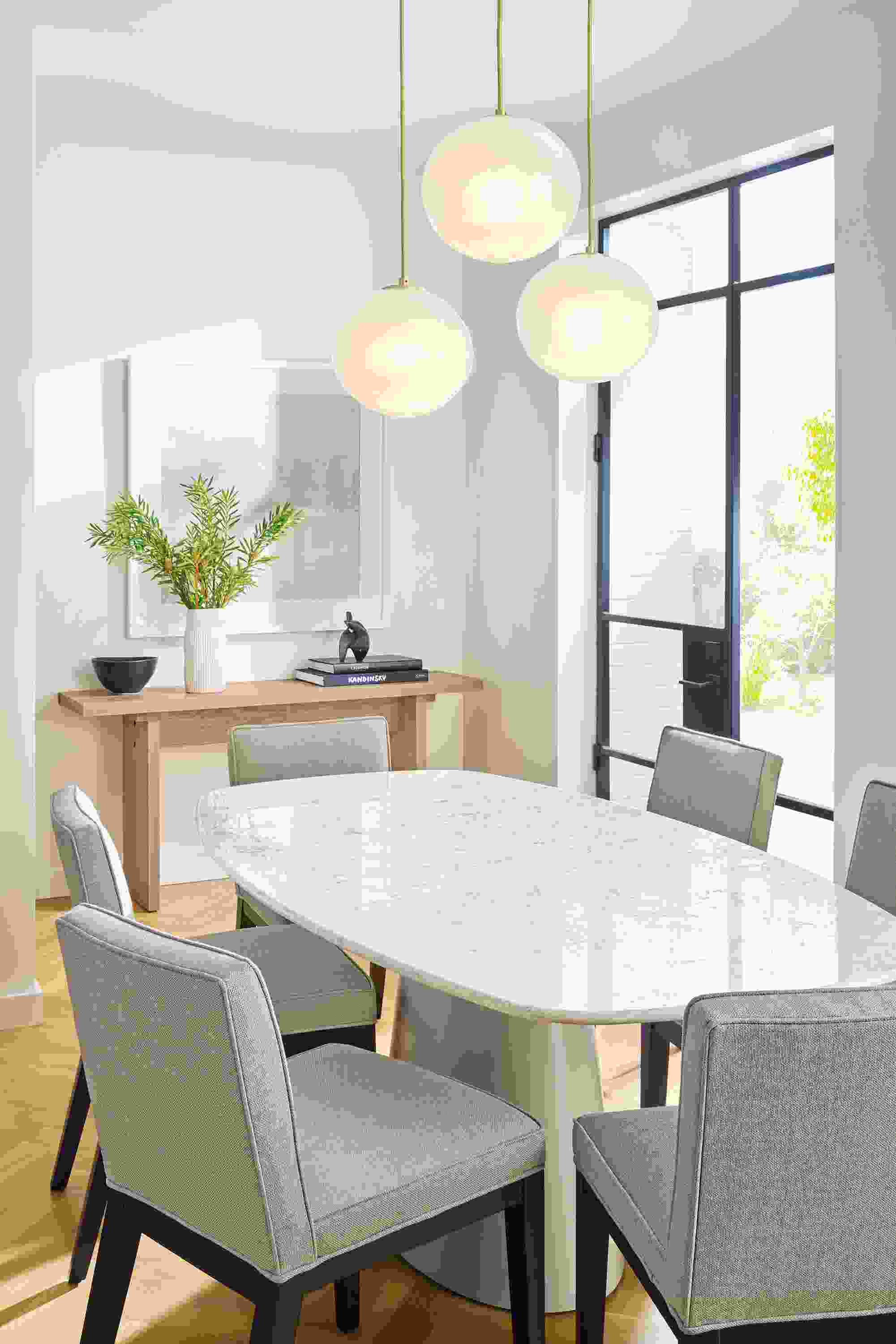 Dining room with Decker boat-top table in taupe and marbled white quartz and 6 Ansel chairs in sumner cement.