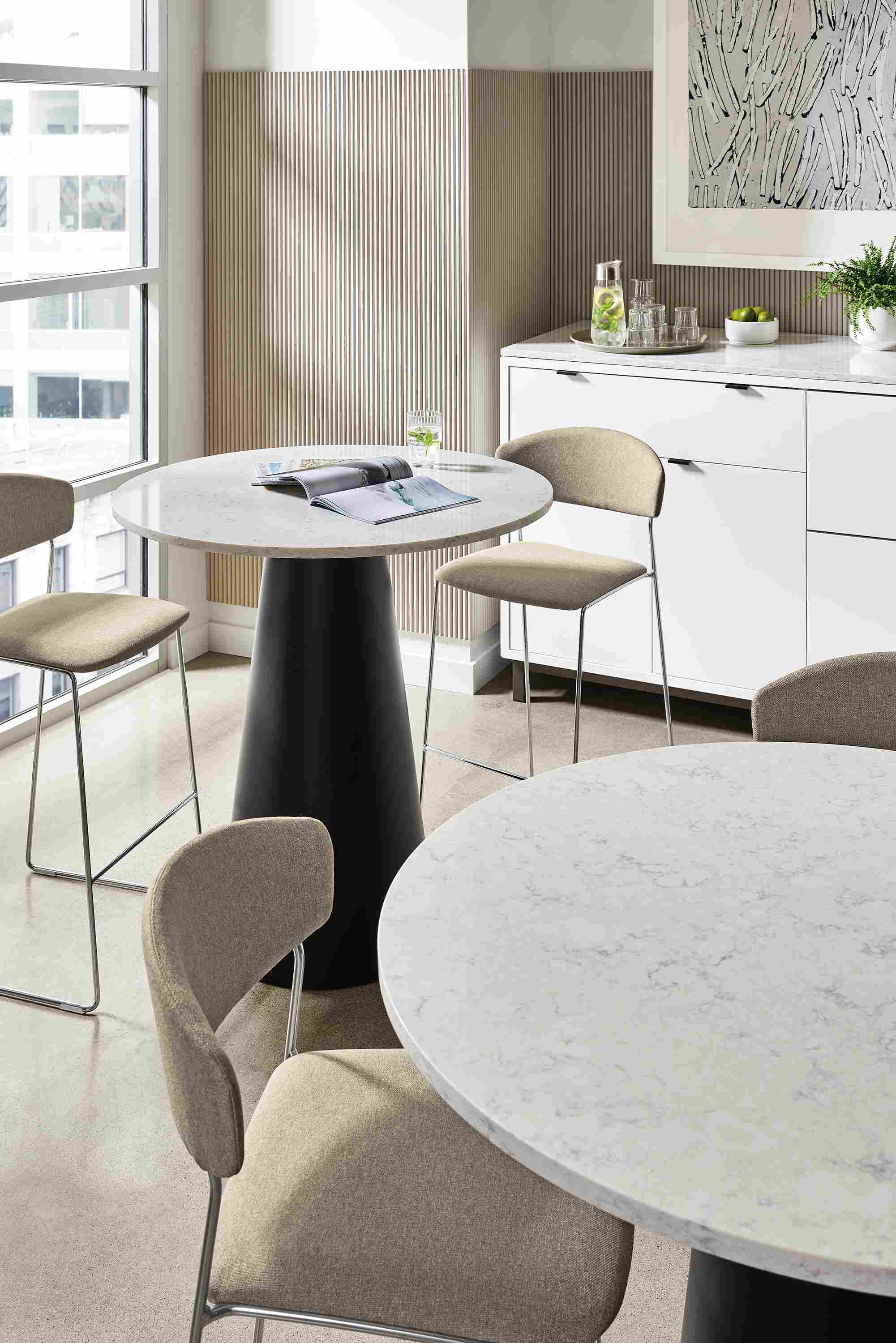 two decker tables in office dining space with wolfgang chairs.