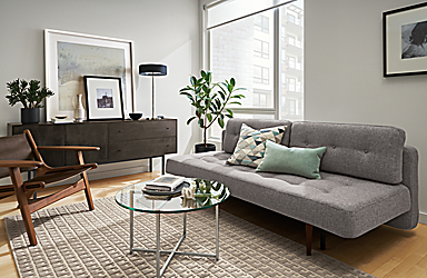 Living room with Deco 79-wide sleeper sofa in Ula Grey, Lars lounge chair in Sellare Smoke and Modo rug in Cement.