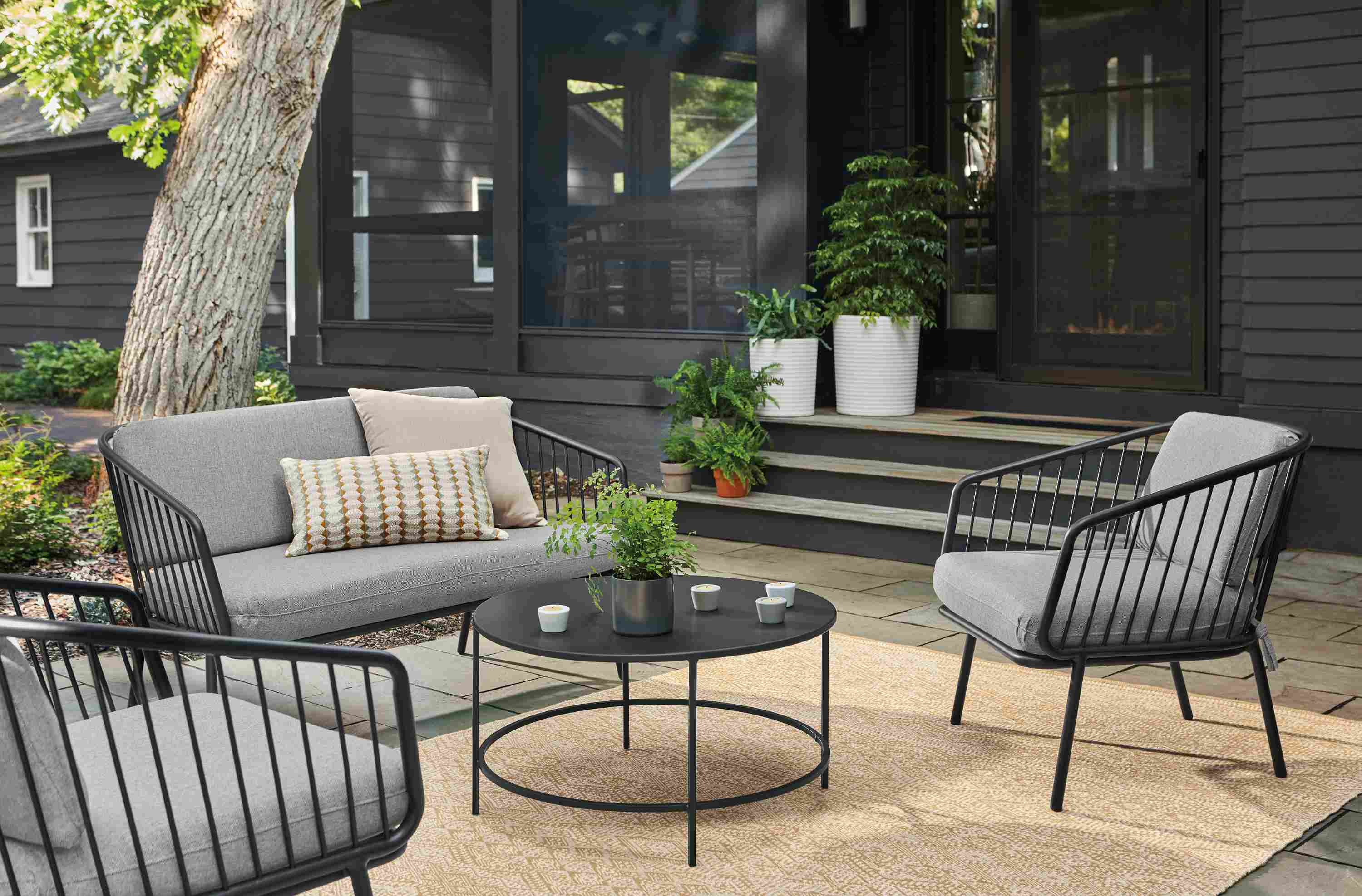 Home patio with Delaney sofa and 2 Delaney chairs in graphite with Noah Cement fabric.