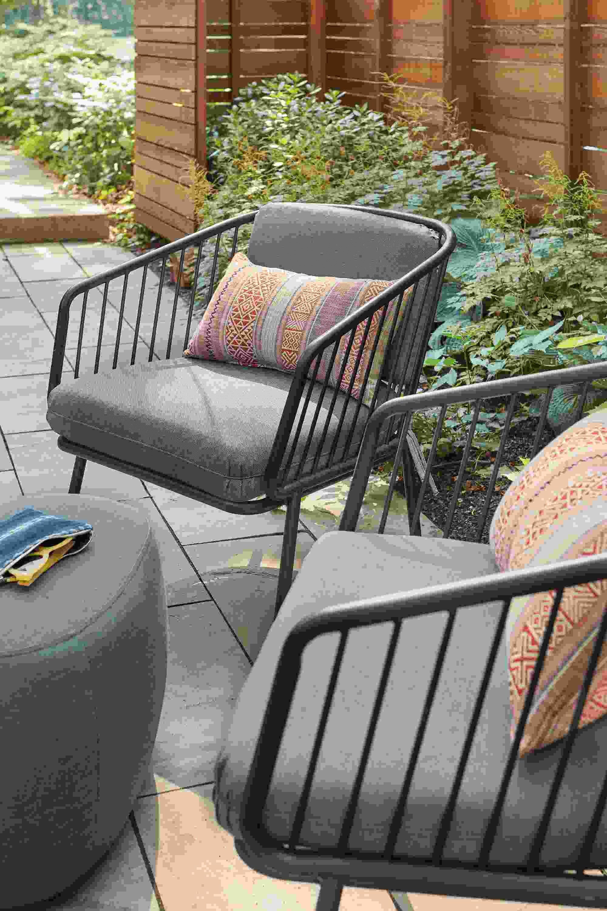 Patio with 2 Delaney lounge chairs in Noah Ink and a Stratford ottoman in Pelham Ink.