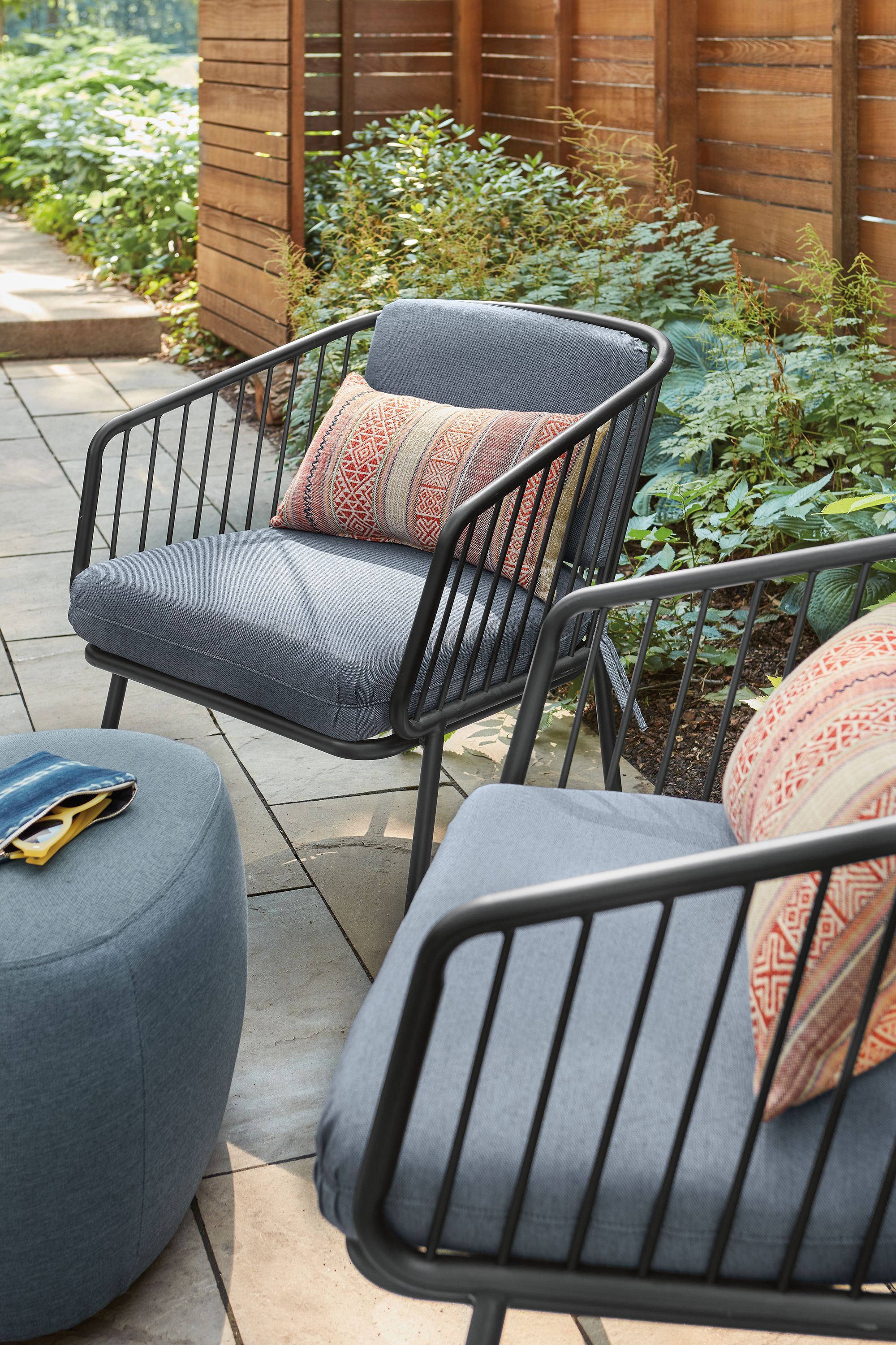 Patio with 2 Delaney lounge chairs in Noah Ink and a Stratford ottoman in Pelham Ink.
