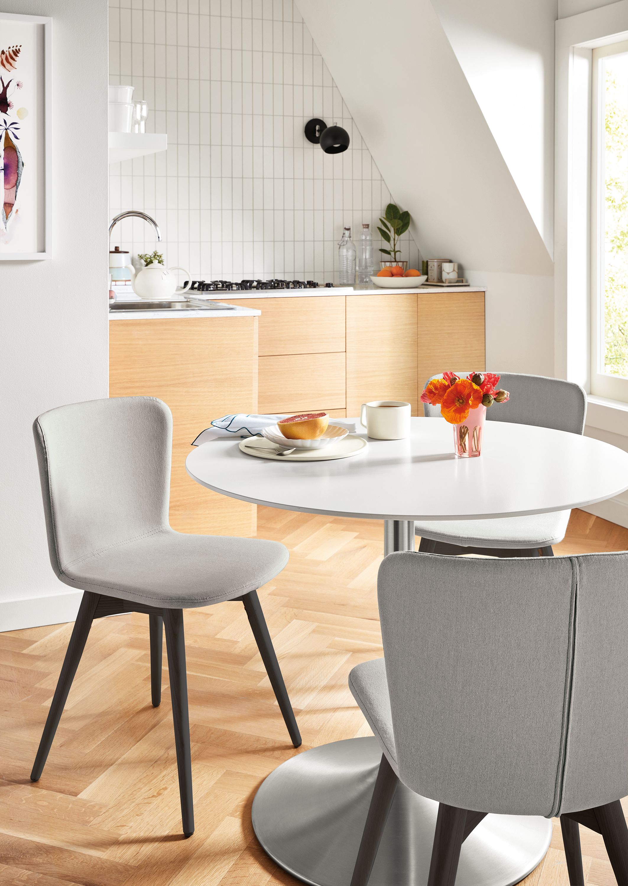room setting with aria table and delilah chairs in creel cement fabric with ebony wood legs in kitchen area.