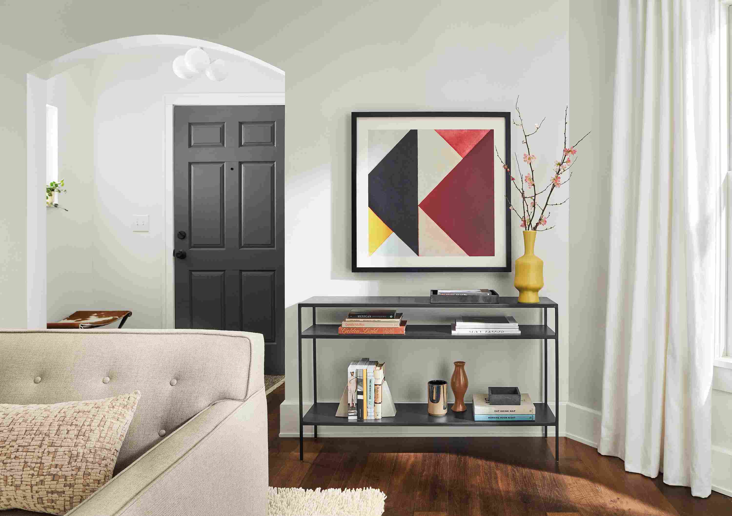 Living area with Slim 48-wide Console Table in Natural Steel with Theo Van Doesburg Artwork hanging on wall above.