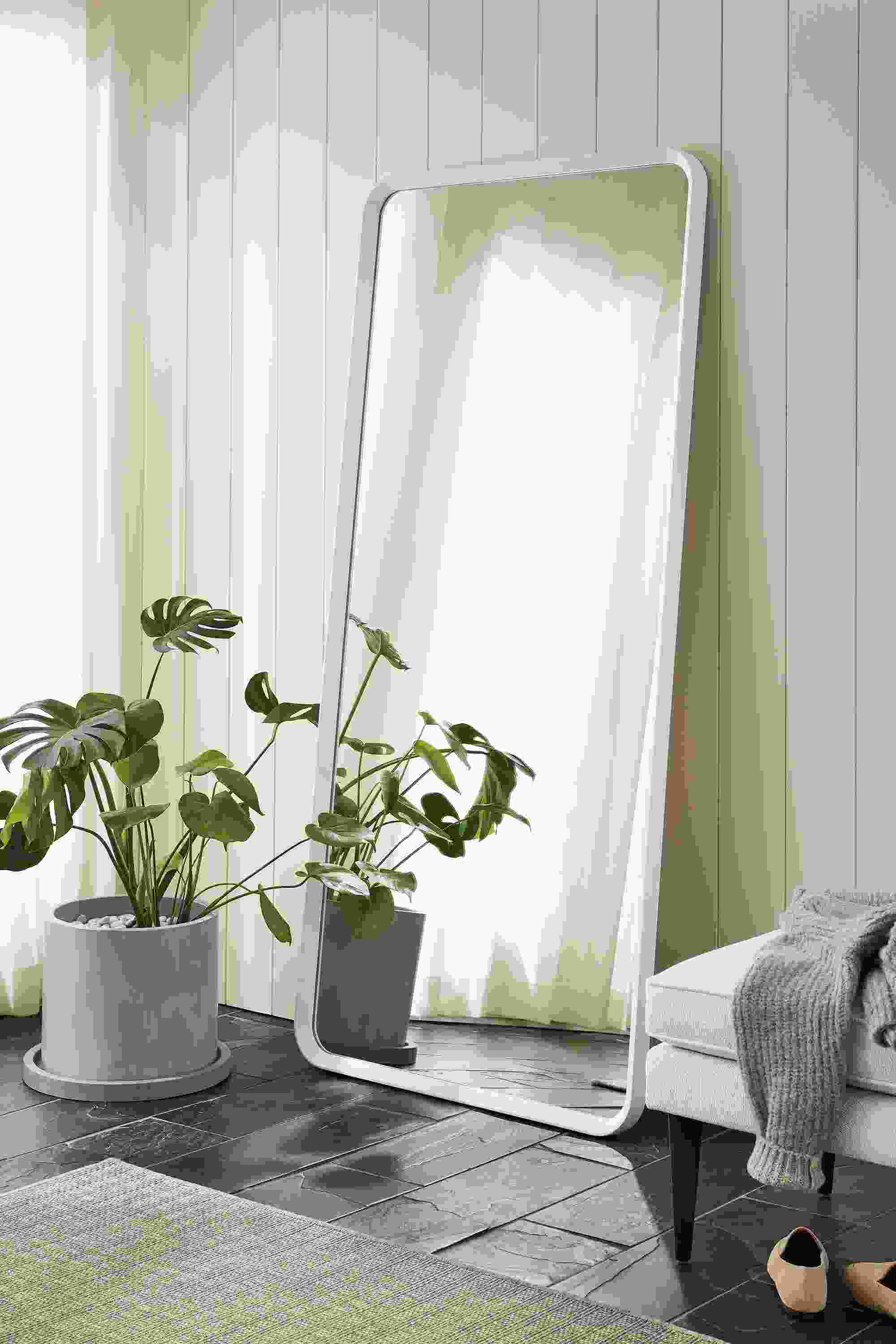Detail of Donahue 31-high by 67-wide mirror in white shown as a floor mirror.