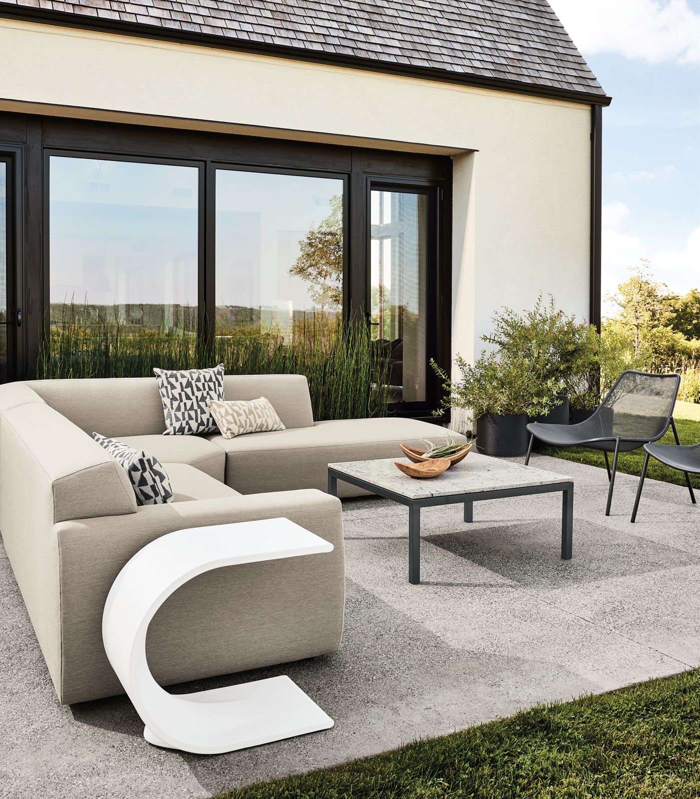 Drift outdoor sectional in Pelham Cement fabric, Tangent c-table in white, Soleil chairs and Parsons coffee table.