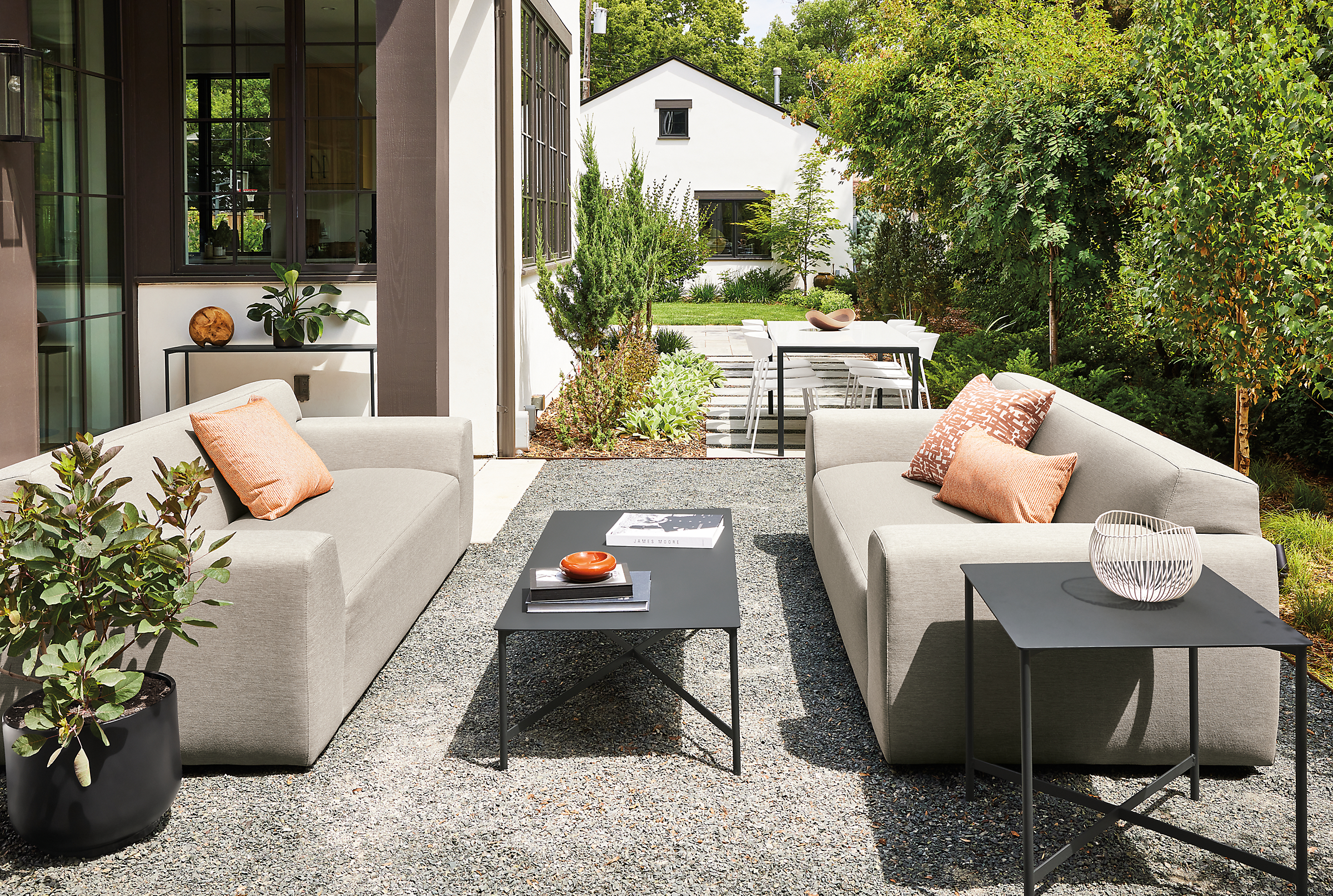 outdoor space with two drift sofas in pelham cement, and circuit coffee table and side table.