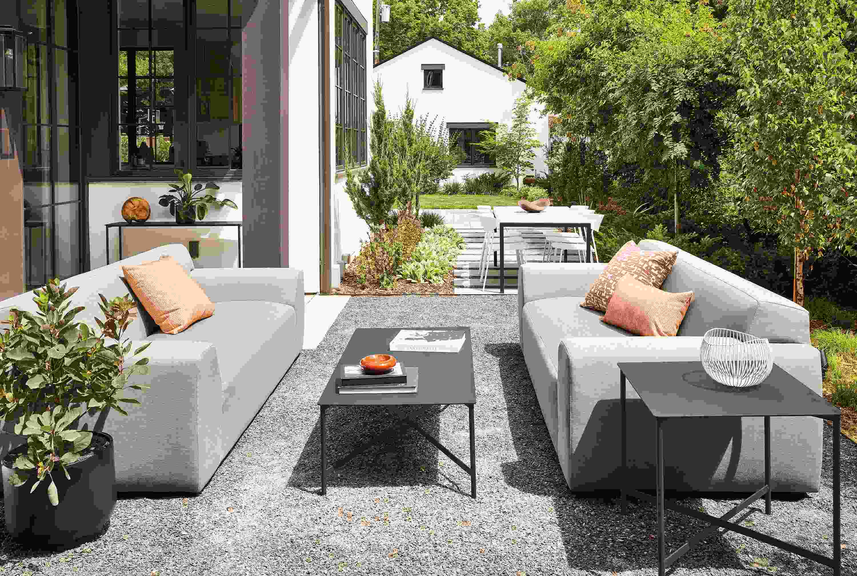 outdoor space with two drift sofas in pelham cement, and circuit coffee table and side table.