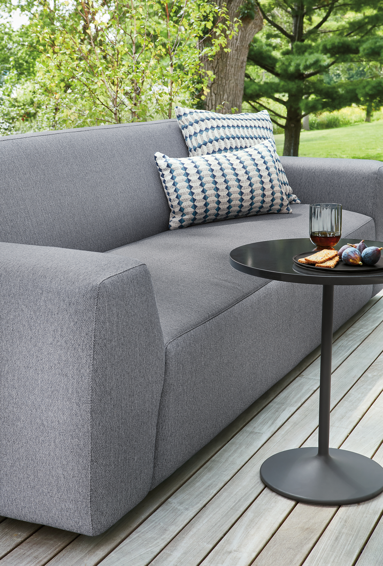 Outdoor space with Drift outdoor sofa and Aria outdoor side table.