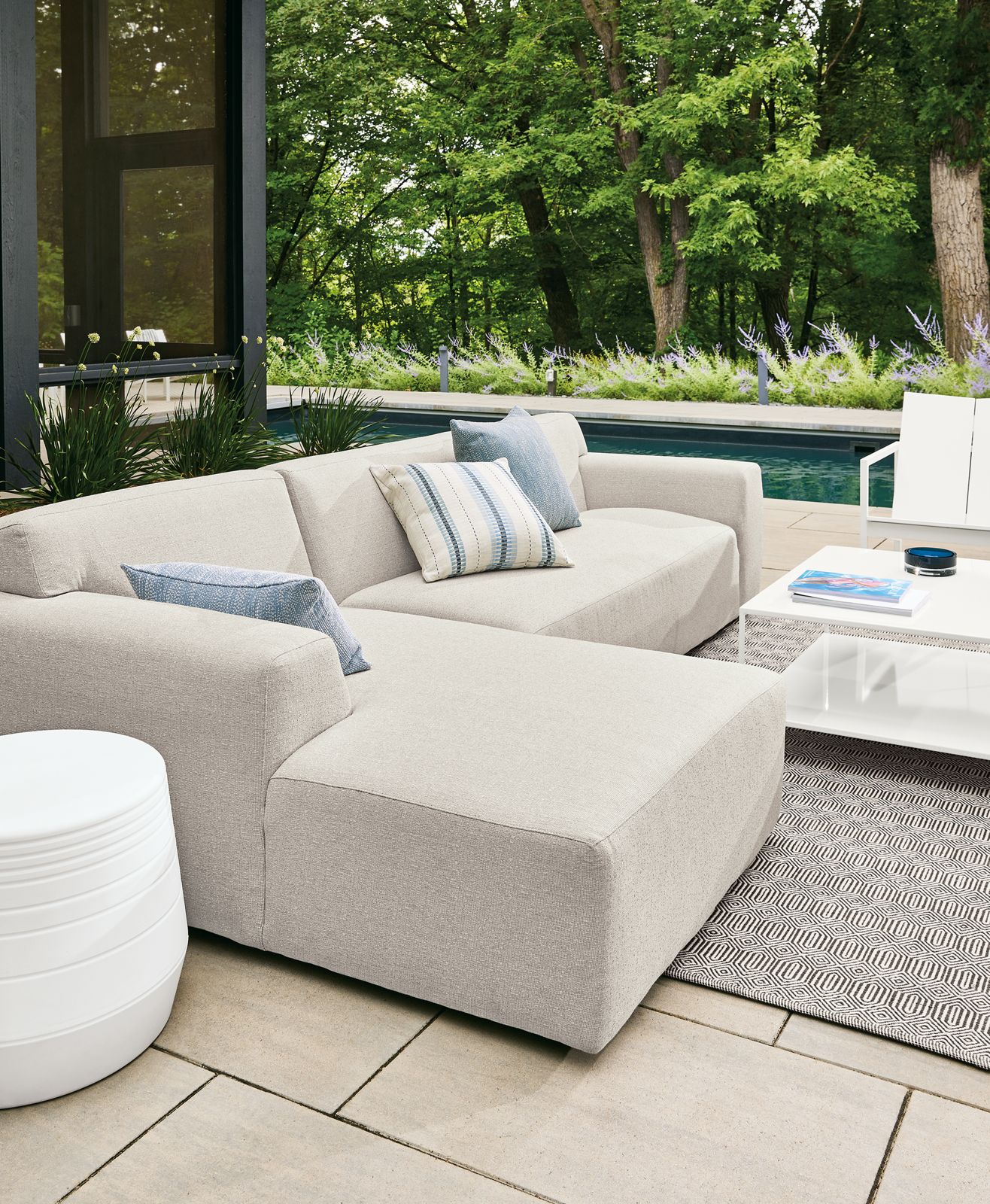 outdoor space with white drift sofa, cusp stool, circuit coffee table.