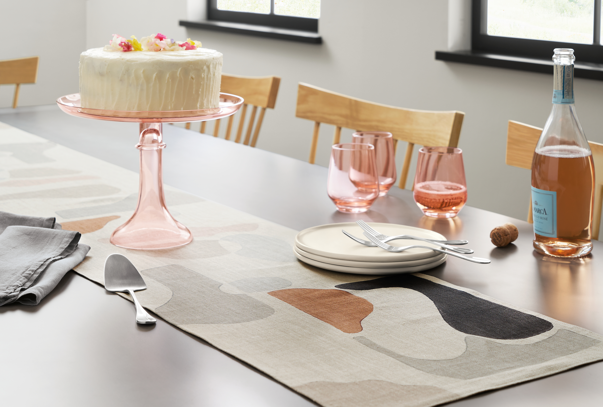 Dining room table with Dune table runner in natural, Estelle glassware and cake stand and Nadia Salad plates.