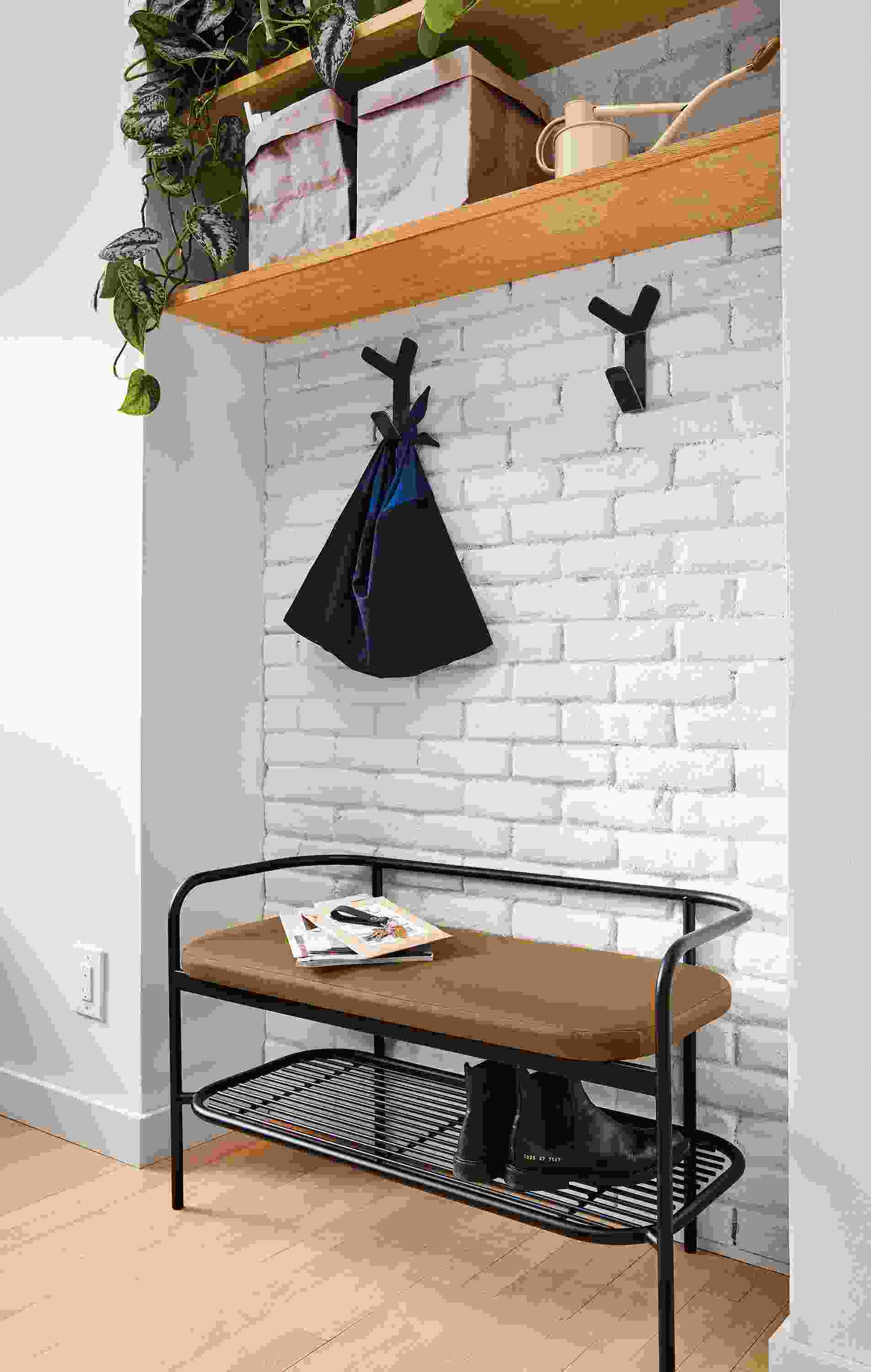 Detail of Ebers bench in graphite and Pesaro Camel leather in entryway.