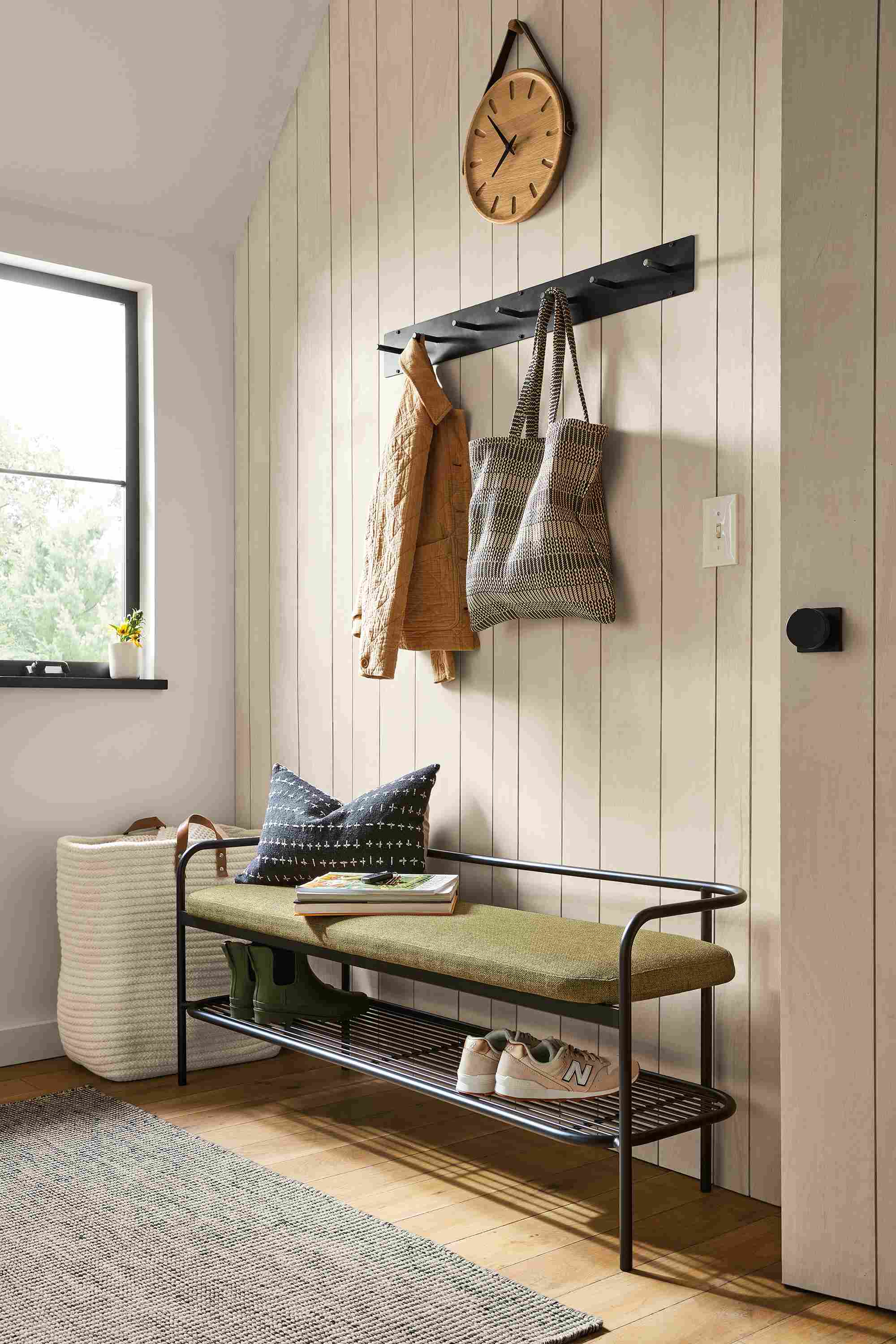 detail of ebers bench with black steel and green fabric in entryway
