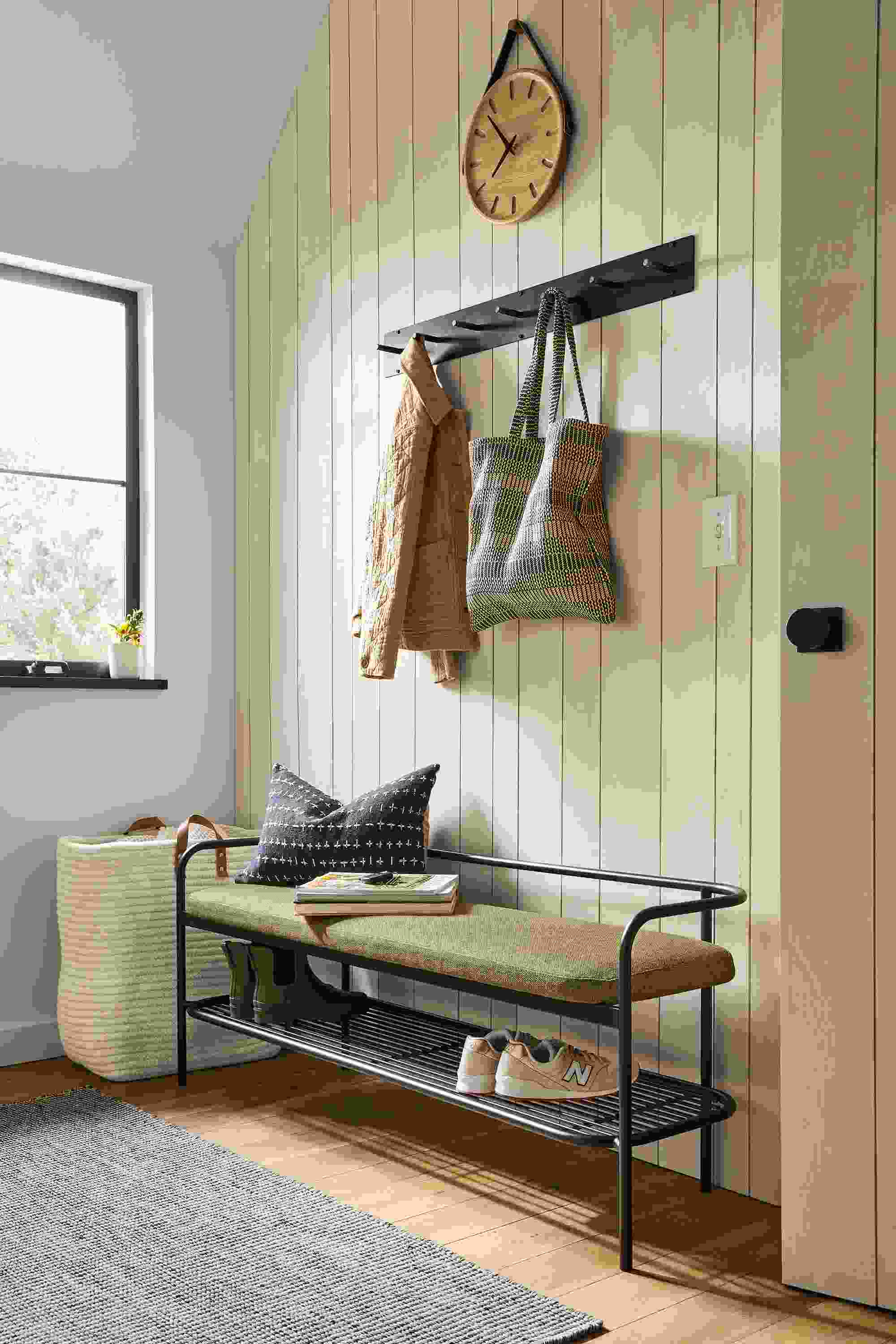 detail of ebers bench with black steel and green fabric in entryway