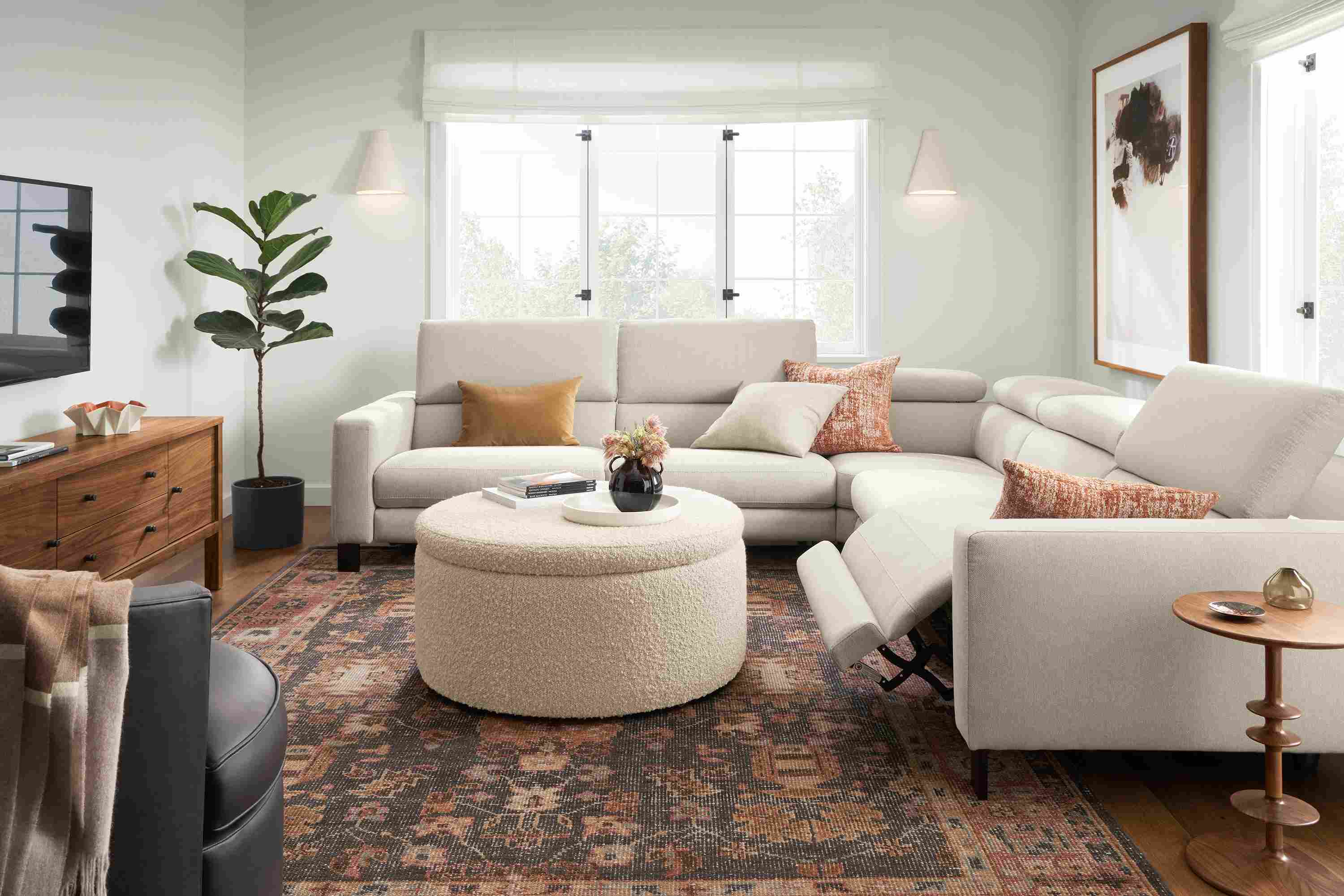 Living room with Elio sectional in sussex cement with one seat shown in reclining position.