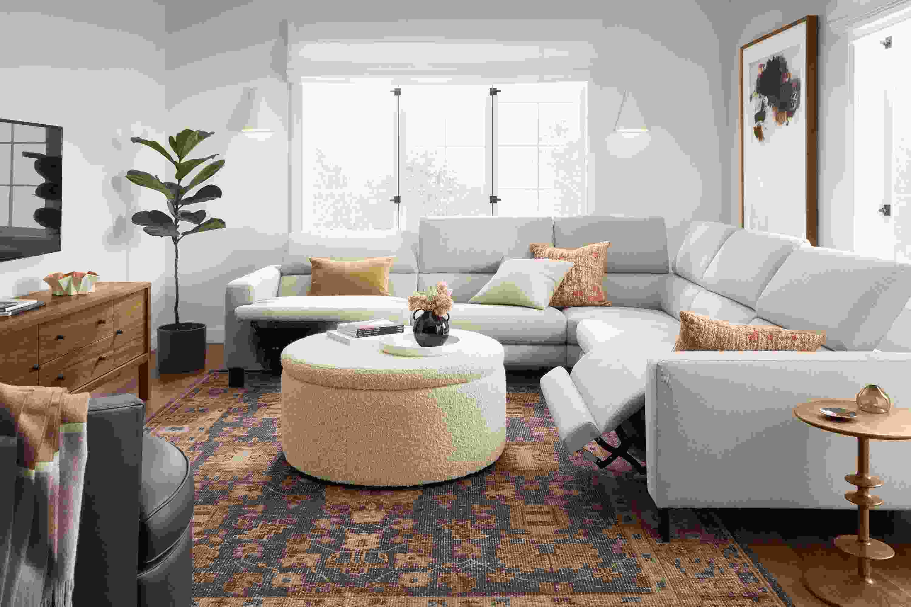 Living room with Elio sectional in sussex cement with two seats shown in reclining position.